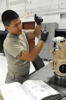 SEYMOUR JOHNSON AIR FORCE BASE, N.C. -- Airman 1st Class Christopher Oliva bolts down a hydraulic start motor onto an F-15E central gear box according to his technical orders here, Nov. 30, 2010. The 4th Fighter Wing propulsion flight out-produced all other F-100 propulsion flights in Air Combat Command combined. Airman Oliva is a 4th Component Maintenance Squadron jet engine mechanic from Sacramento, Calif.  (U.S. Air Force photo/Staff Sgt. Courtney Richardson)