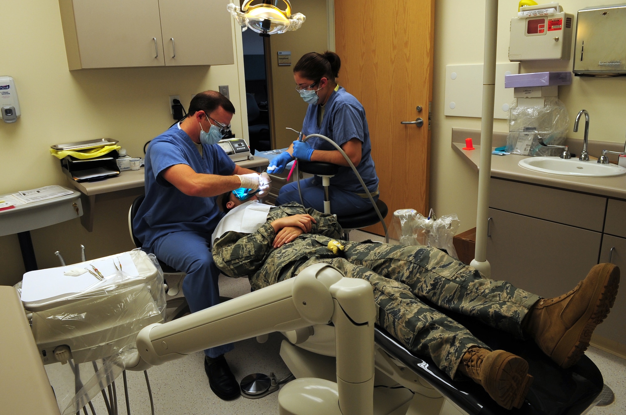 MOODY AIR FORCE BASE, Ga. --  Dr. (Capt.) Edward Trouy, 23rd Aeromedical Dental Squadron dentist and Airman 1st Class Natalie Hellwig, 23rd AMDS dental assistant, perform a dental filling procedure on Airman 1st Class Faith Crawford, 824th Base Defense Squadron, in the dental treatment room  Nov. 24. The DTR is one of the newly remodeled rooms in the dental clinic expansion opening, Dec. 2. (U.S. Air Force photo/Senior Airman Stephanie Mancha)(RELEASED))