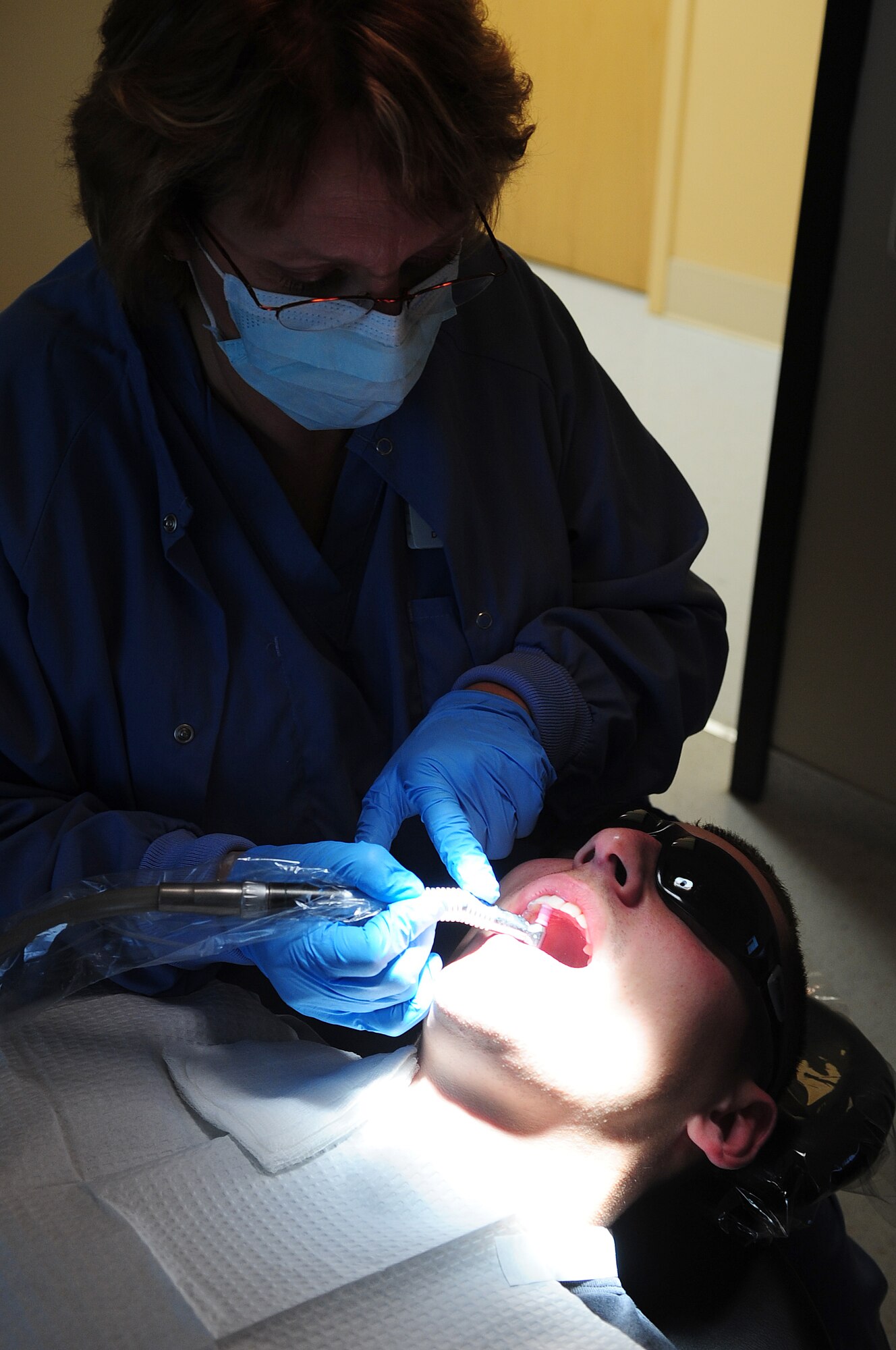 MOODY AIR FORCE BASE, Ga.-- Cindy Allen, 23rd Aeromedical Dental Squadron dental hygienist, polishes the teeth of  Staff Sgt. William Strauss, 23rd Civil Engineer Squadron firefighter, with prophylaxis  paste, a special gritty toothpaste, Nov. 24. Polishing teeth is one of the steps  during a dental routine cleansing. (U.S. Air Force photo/Senior Airman Stephanie Mancha)(RELEASED)
