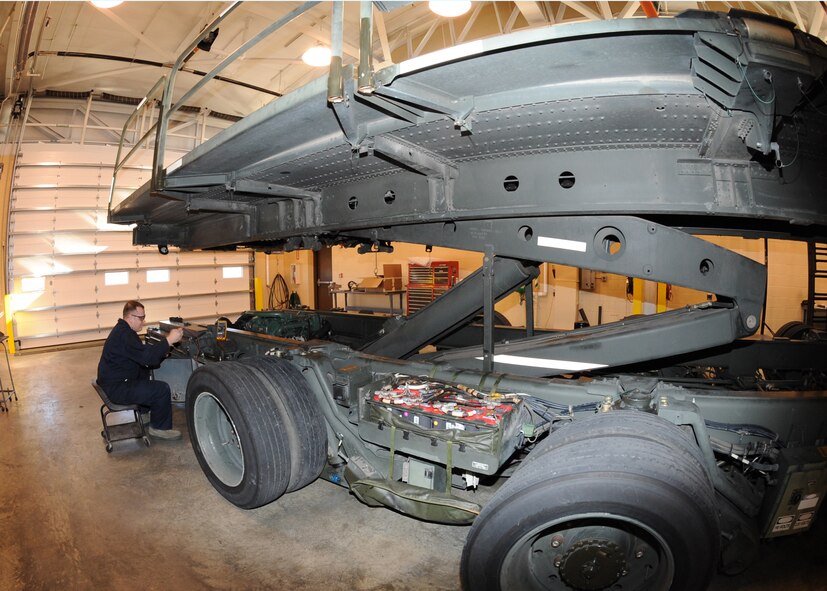 Senior Airman Andrew Sterrett, 22nd Logistics Readiness Squadron vehicle equipment and equipment mechanic, replaces a bed stop cable on a dump truck, Dec. 1, 2010, McConnell Air Force Base, Kan.  The cable cuts the hydraulics and prevents the bed of the truck from over extending. Vehicle maintenance personnel’s main duties include determining the overall mechanical condition of vehicles and equipment and correcting any deficiencies.  (U.S. Air Force photo/Airman 1st Class Katrina M. Brisbin)
