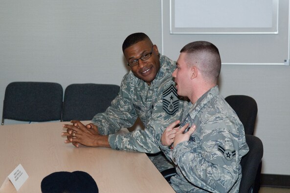 Airman 1st Class Brent Seebeck speaks with Chief Master Sgt. Kenneth Williams, Electronic Systems Center command chief, about the Enlisted Force Structure during the First Term Airman’s Center course on Nov. 17, 2010. The week-long course teaches first-term Airman at Hanscom about the many base resources available to help them have a successful Air Force career. This was the largest FTAC class to date. (U.S. Air Force photo/Rick Berry)