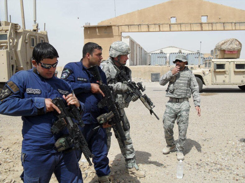 Tech. Sgt. William C. Boyden (second from right) works with Iraqi police members during a weapons training session. Sergeant Boyden recently returned from a seven month deployment from Iraq and was awarded a Bronze Star for meritorious service because of his leadership and efforts to develop a legitimate and competent Iraqi police force. (Courtesy photo)