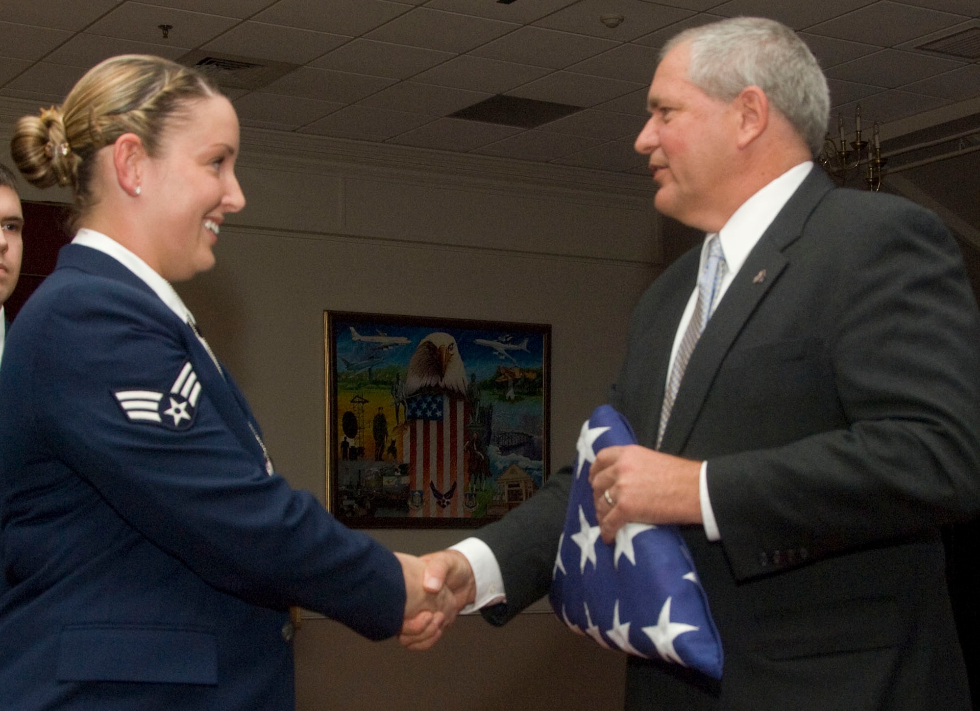 HANSCOM AIR FORCE BASE, Mass. - Senior Airman Samantha M. Dejongh (left) greets Cory Etchberger during the Airman Leadership School Class 11A graduation at the Minuteman Club on Nov. 19. Cory Etchberger served as the special guest during the ceremony. His father was Chief Master Sgt. Richard L. Etchberger, who was posthumously awarded the Medal of Honor for his actions in a remote site in Laos in 1968. (U.S. Air Force photo by Lance Beebe)