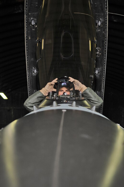 SPANGDAHLEM AIR BASE, Germany –Capt. Thomas Young, 480th Fighting Squadron F-16 Fighting Falcon pilot, puts his helmet on while performing a pre-flight inspection in the cockpit of an F-16 Dec. 2. Captain Young and five other pilots from the 480th FS have completed Allied Command Europe’s Tactical Leadership Program this year to move from flight lead of four aircraft to command a 30-ship force. (U.S. Air Force photo/Senior Airman Nick Wilson)