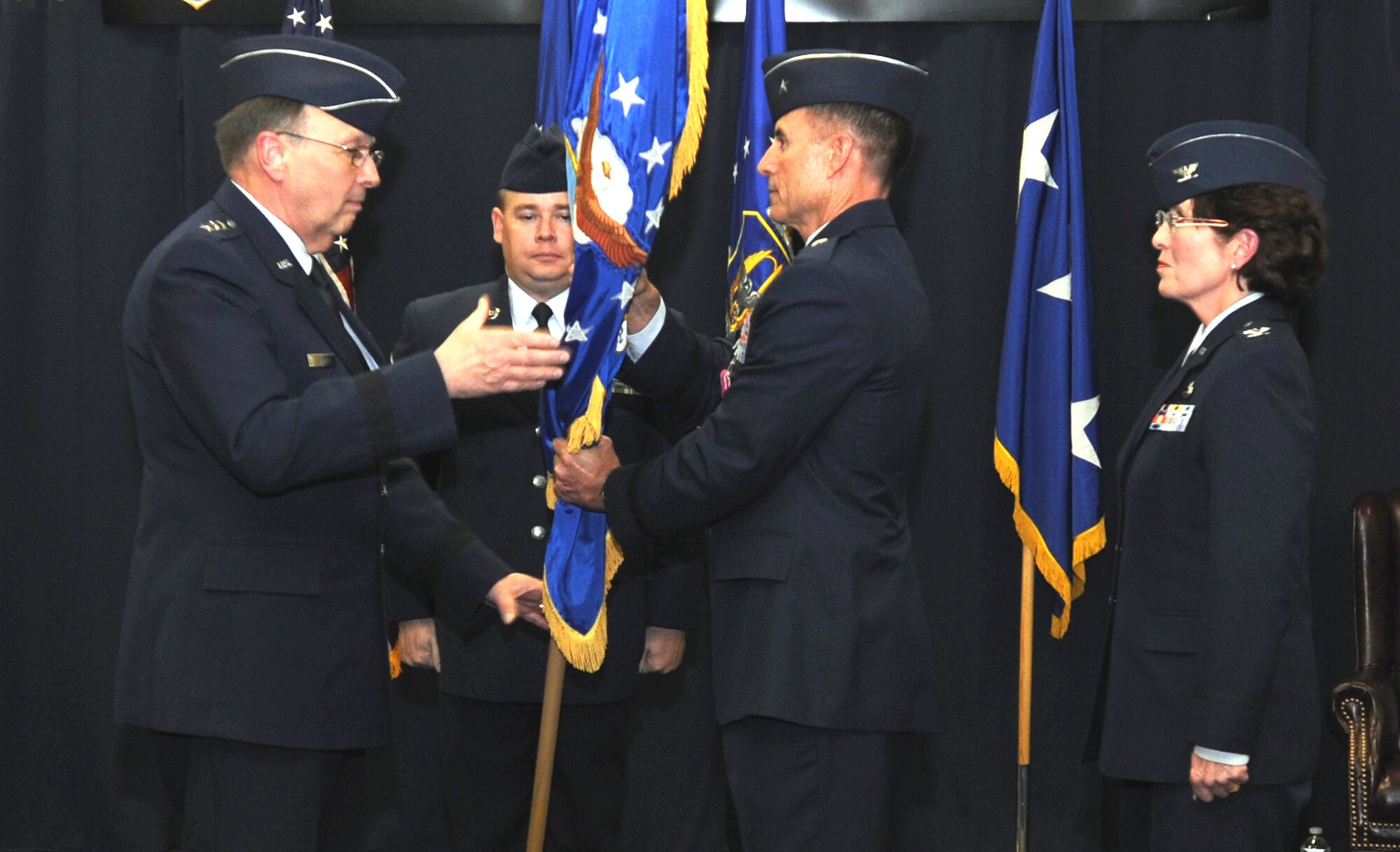 From left: Lt. Gen. Charles E. Stenner, Jr., commander of Air Force Reserve Command, accepts the Air Reserve Personnel Center flag from Brig. Gen. Kevin E. Pottinger, who relinquished command of the center to Col. Patricia Blassie Nov. 29, 2010, in Denver. Colonel Blassie was the executive officer to the Chief of the Air Force Reserve before assuming command at ARPC. General Pottinger will become the mobilization assistant to the Assistant Secretary of the Air Force for Manpower and Reserve Affairs in the Pentagon. (U.S. Air Force photo/Kevin Bell) 