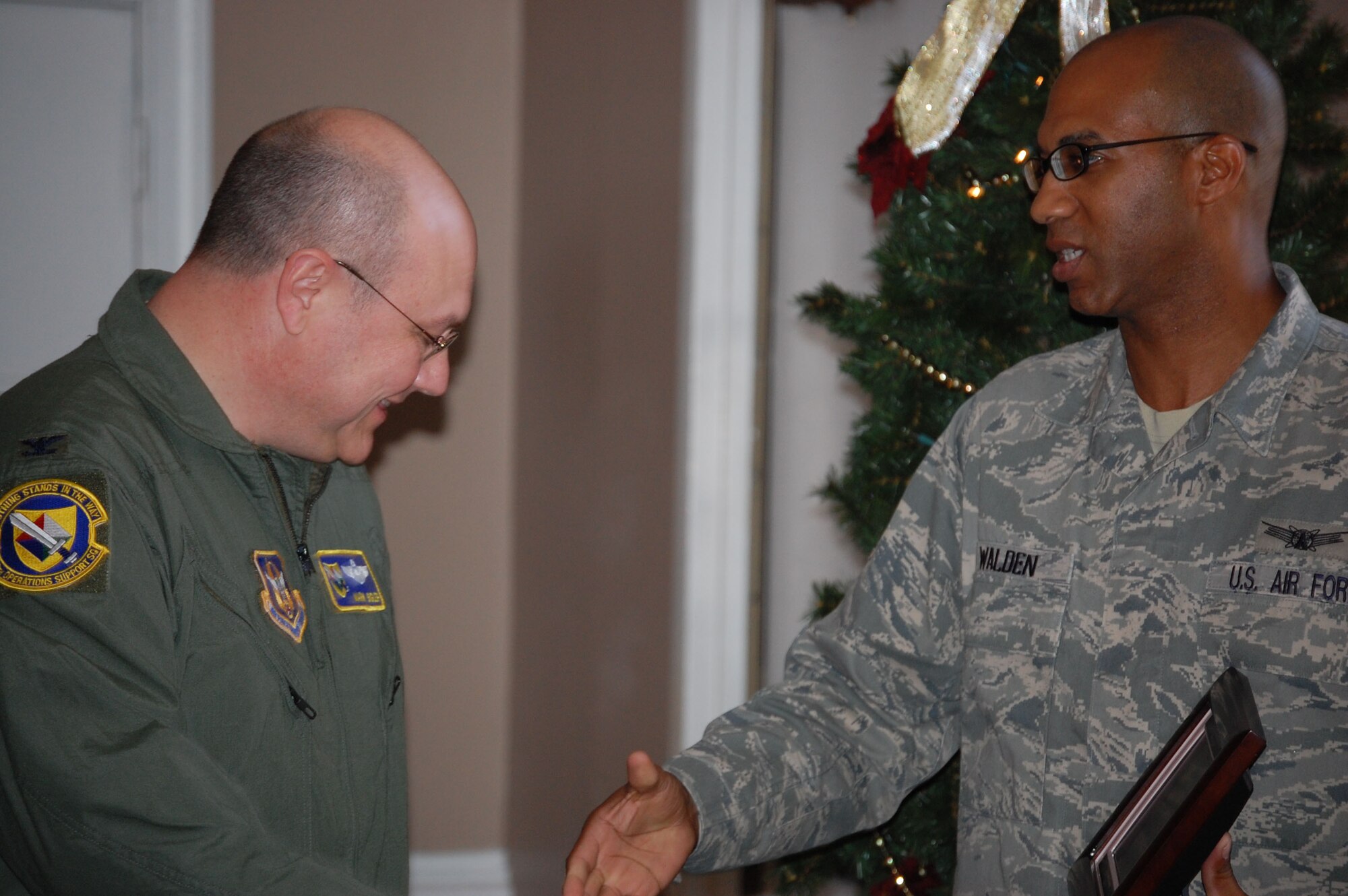 Lt. Col. Mark Sigler (left) looks at the digital picture frame he received from Tech. Sgt. Christopher Walden, crew communications. The crew comm staff presented the 916th Operations Support Squadron commander with a going-away gift upon his departure for March Air Reserve Base, Calif. (USAF photo by Maj. Shannon Mann, 916PA)
