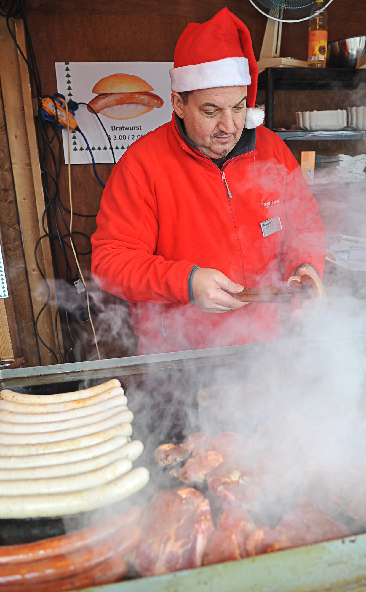 Roland Omlor, Mr. Big sports bar and American restaurant, cooks on the grill at the mini Christmas Market outside of the KMCC entrance, Ramstein Air Base, Germany, Dec. 2, 2010. (U.S. Air Force photo by Airman 1st Class Desiree Esposito)