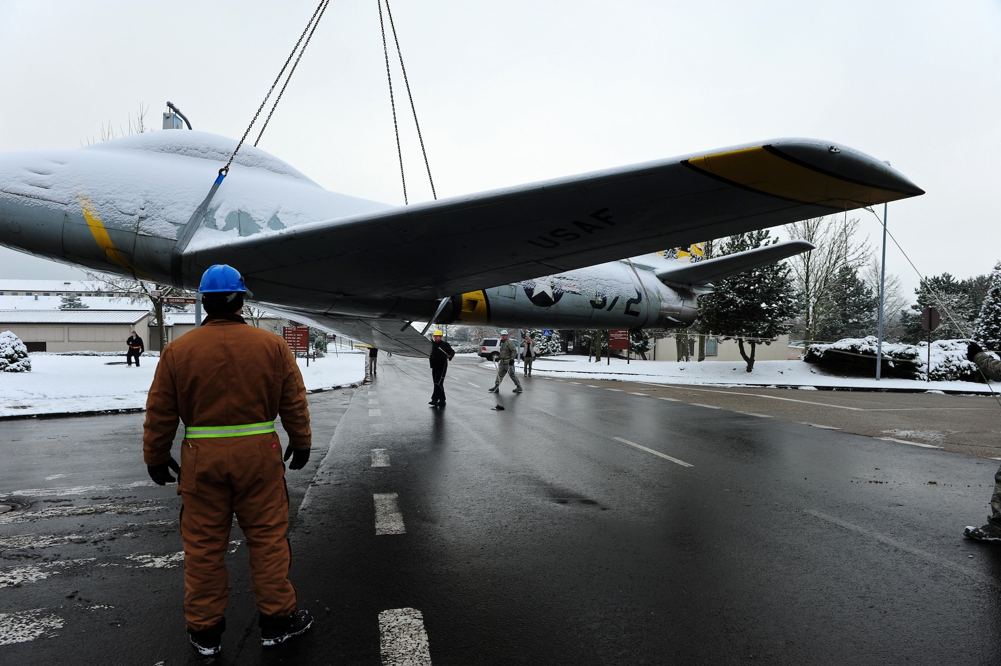 U.S. Air Force personnel from the 86th Maintenance Squadron help lower a F-86F Sabre jet after it's removal from a concrete mount, Sembach Annex, Germany, Nov. 30, 2010. The aircraft will be refurbished and redisplayed at Ramstein Air Base Hardened Aircraft Shelter as a representative F-86F aircraft from the 86th Fighter Bomber Wing. (U.S. Air Force photo by Airman 1st Class Brea Miller)