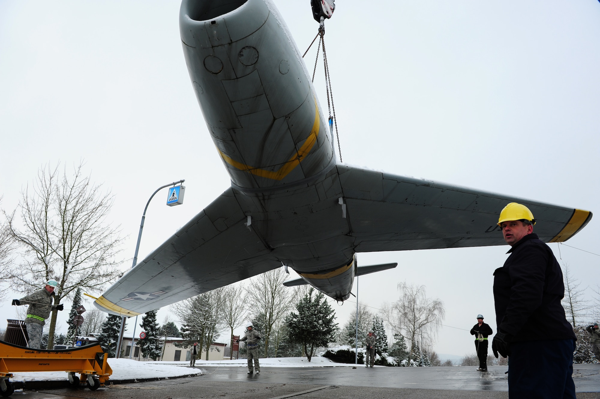 U.S. Air Force personnel from the 86th Maintenance Squadron help lower a F-86F Sabre jet after it's removal from a concrete mount, Sembach Annex, Germany, Nov. 30, 2010. The aircraft will be refurbished and redisplayed at Ramstein Air Base Hardened Aircraft Shelter as a representative F-86F aircraft from the 86th Fighter Bomber Wing. (U.S. Air Force photo by Airman 1st Class Brea Miller)