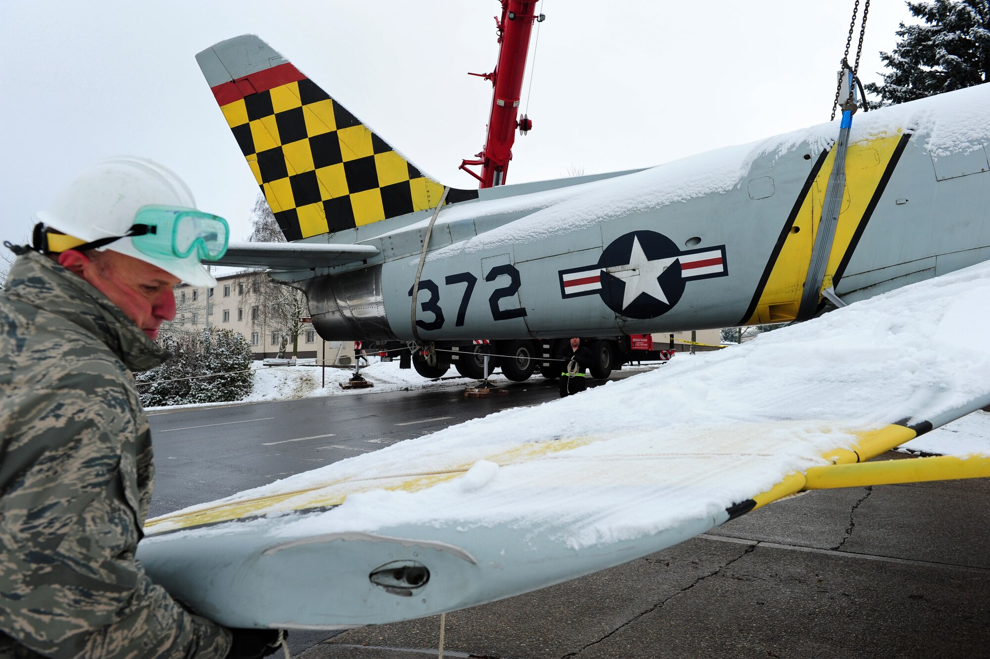 U.S. Air Force Master Sgt. James Hill, 86th Maintenance Squadron flight chief, helps lower a F-86F Sabre jet, Sembach Annex, Germany, Nov. 30, 2010. The aircraft will be refurbished and redisplayed at Ramstein Air Base Hardened Aircraft Shelter as a representative F-86F aircraft from the 86th Fighter Bomber Wing. (U.S. Air Force photo by Airman 1st Class Brea Miller)