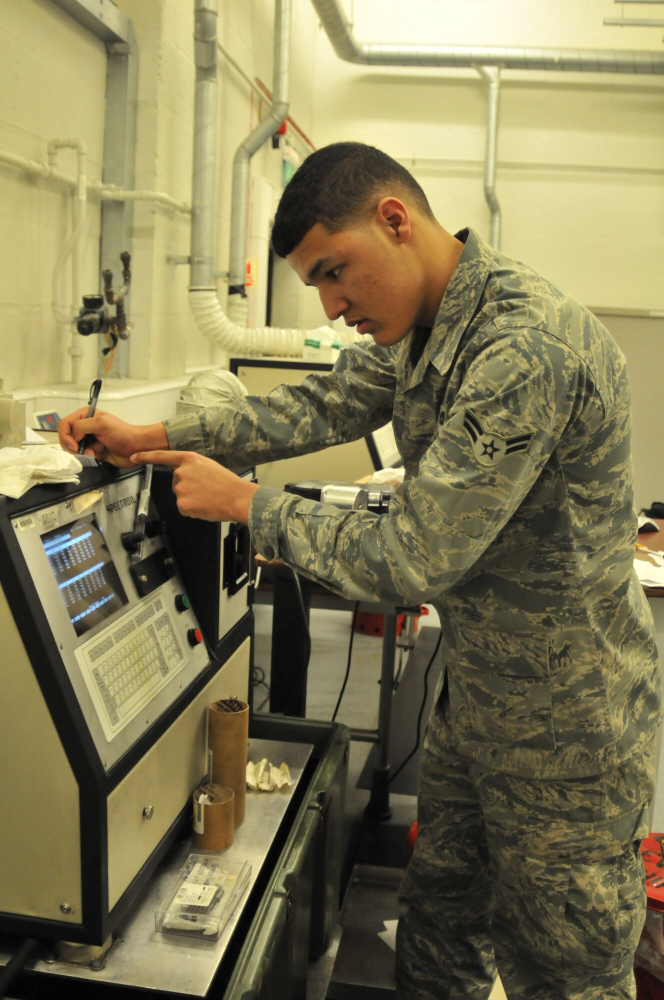 ROYAL AIR FORCE LAKENEHEATH, England – Airman 1st Class Anthony Taylor, 48th Equipment Maintenance Squadron nondestructive inspection apprentice, transcribes data from an oil analysis machine Dec. 1. The machine tests oil from aircraft engines for impurities that could potentially cause a failure. Airman Taylor was nominated for a Liberty Spotlight because he portrays the core value ‘Excellence in All We Do.’ (U.S. Air Force photo/Senior Airman David Dobrydney)