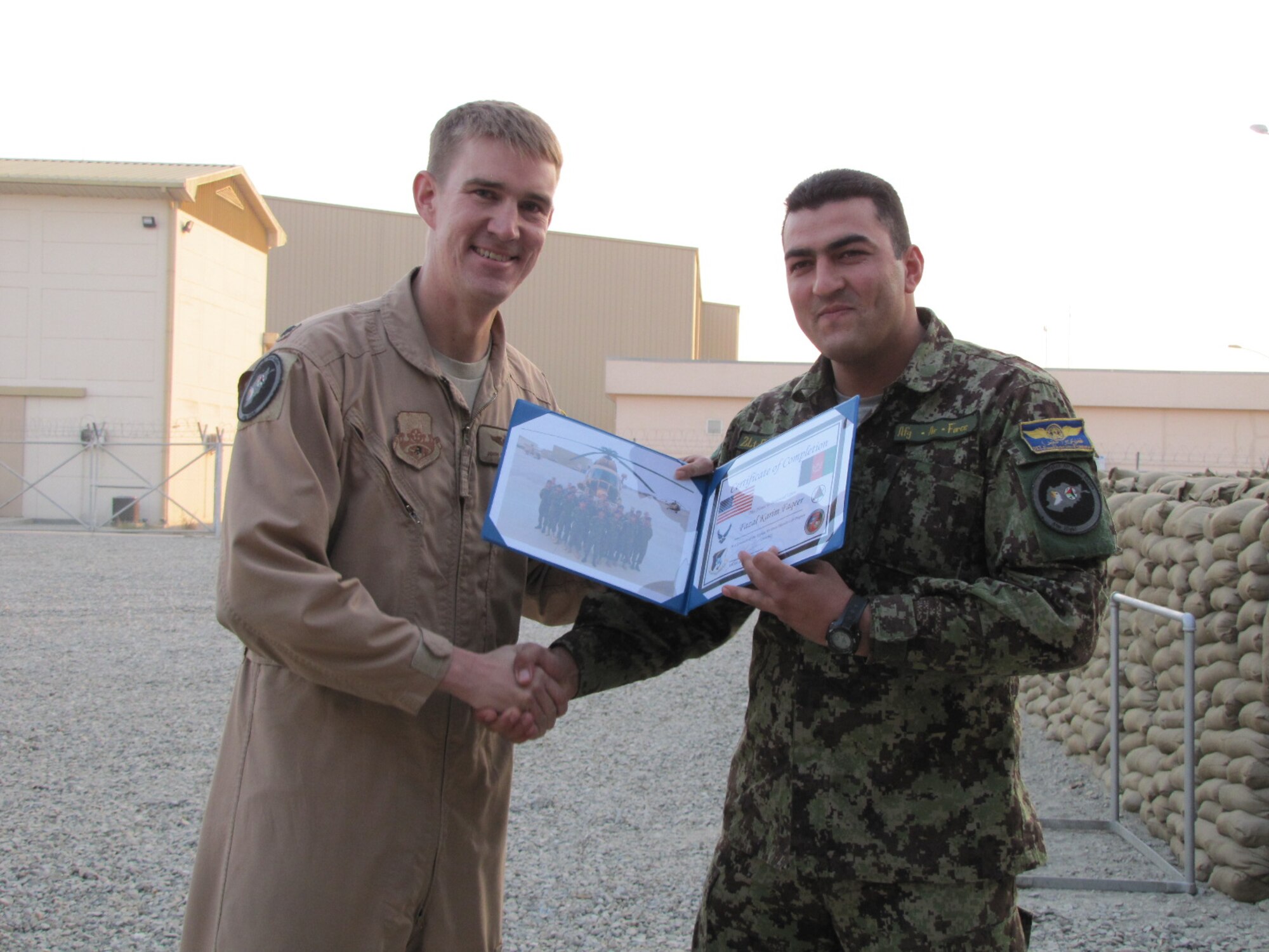 KABUL, Afghanistan - Afghan Air Force Lieutenants Jawid Karimi and Fazal Karim Faqeer graduate from the English Immersion Lab known as the Thunder Lab on Dec 1, 2010.  They will head to the United State for more advanced English and pilot training.  (U.S. Air Force photo by Capt. Rob Leese/RELEASED).