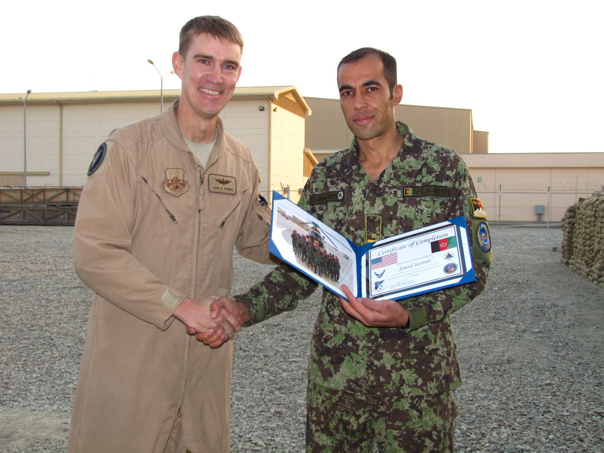 KABUL, Afghanistan - Afghan Air Force Lieutenants Jawid Karimi and Fazal Karim Faqeer graduate from the English Immersion Lab known as the Thunder Lab on Dec 1, 2010.  They will head to the United State for more advanced English and pilot training.  (U.S. Air Force photo by Capt. Rob Leese/RELEASED).
