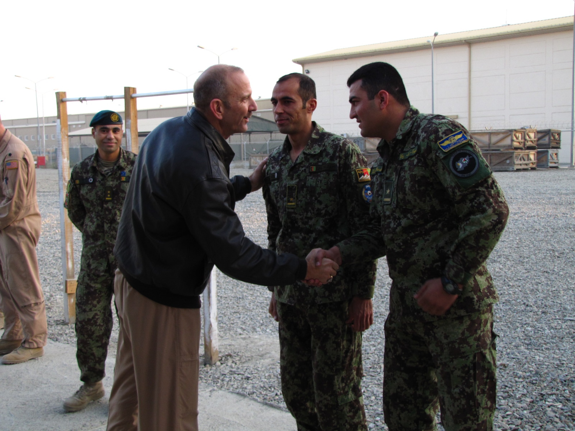 KABUL, Afghanistan - Col. Creig Rice, Vice Commander of the NATO Air Training Command-Afghanistan congratulates Afghan Air Force Lieutenants Jawid Karimi and Fazal Karim Faqeer as they graduate from the English Immersion Lab known as the Thunder Lab on Dec 1, 2010.  They will head to the United State for more advanced English and pilot training.  (U.S. Air Force photo by Capt. Rob Leese/RELEASED).
