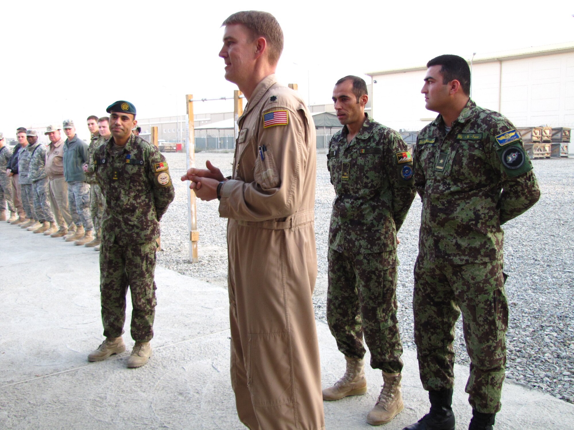KABUL, Afghanistan - Lt. Col. John Howard, Officer-in-Charge of the Afghan Air Force English Immersion Lab congratulates Afghan Air Force Lieutenants Jawid Karimi and Fazal Karim Faqeer as they graduate from the English Immersion Lab known as the Thunder Lab on Dec 1, 2010.  They will head to the United State for more advanced English and pilot training.  (U.S. Air Force photo by Capt. Rob Leese/RELEASED).
