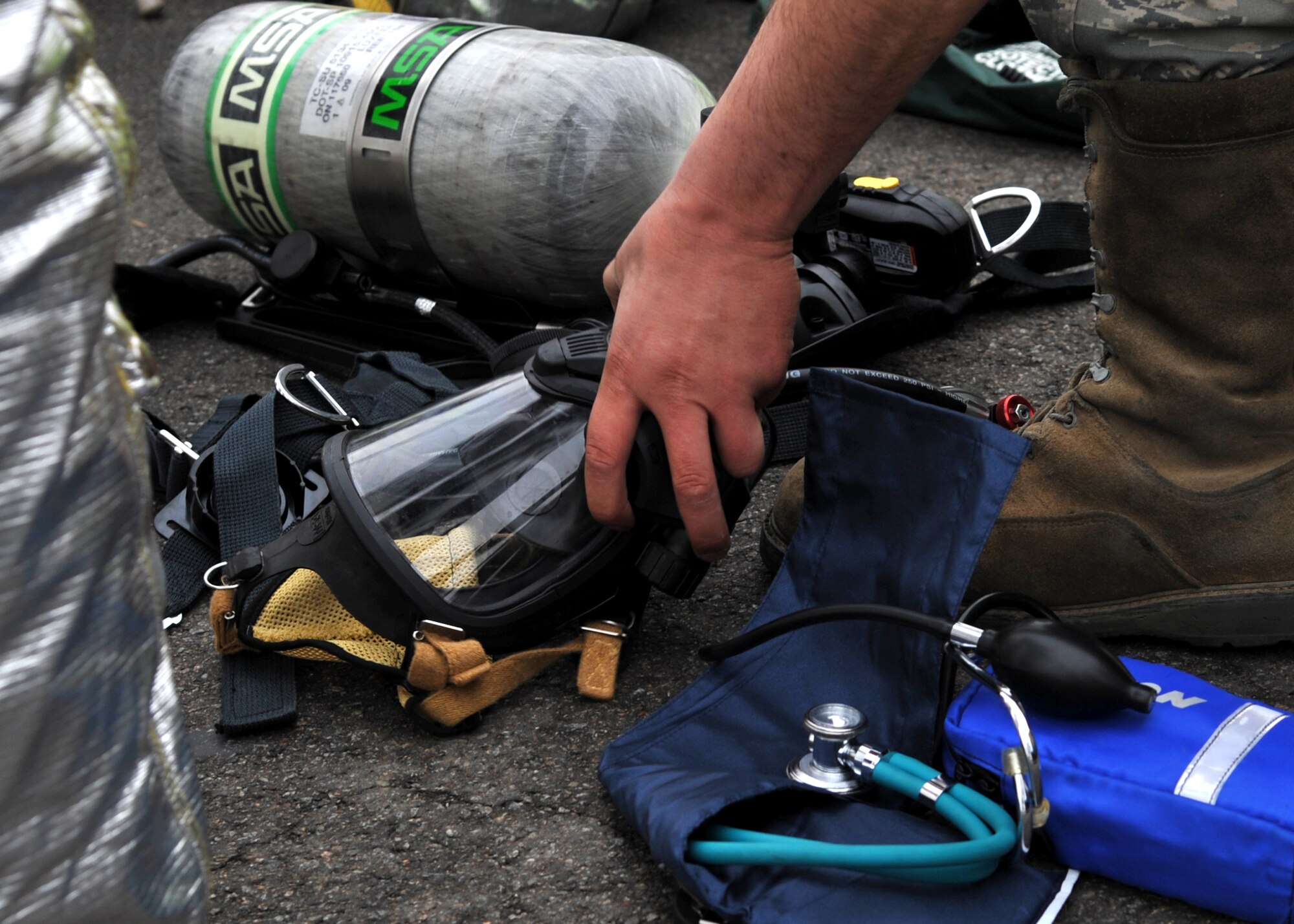 An Airman prepares his gear before entering a "contaminated" room during an Emergency Management Exercise (EME) Dec. 1. The exercise simulated a biological attack. A "hostile Airman" planted a device in the HVAC
system of a dorm room to disperse aerosolized botulism.  The exercise was designed to evaluate emergency responders and search and recovery efforts. (U.S. Air Force Photo /Senior Airman Evelyn Chavez)