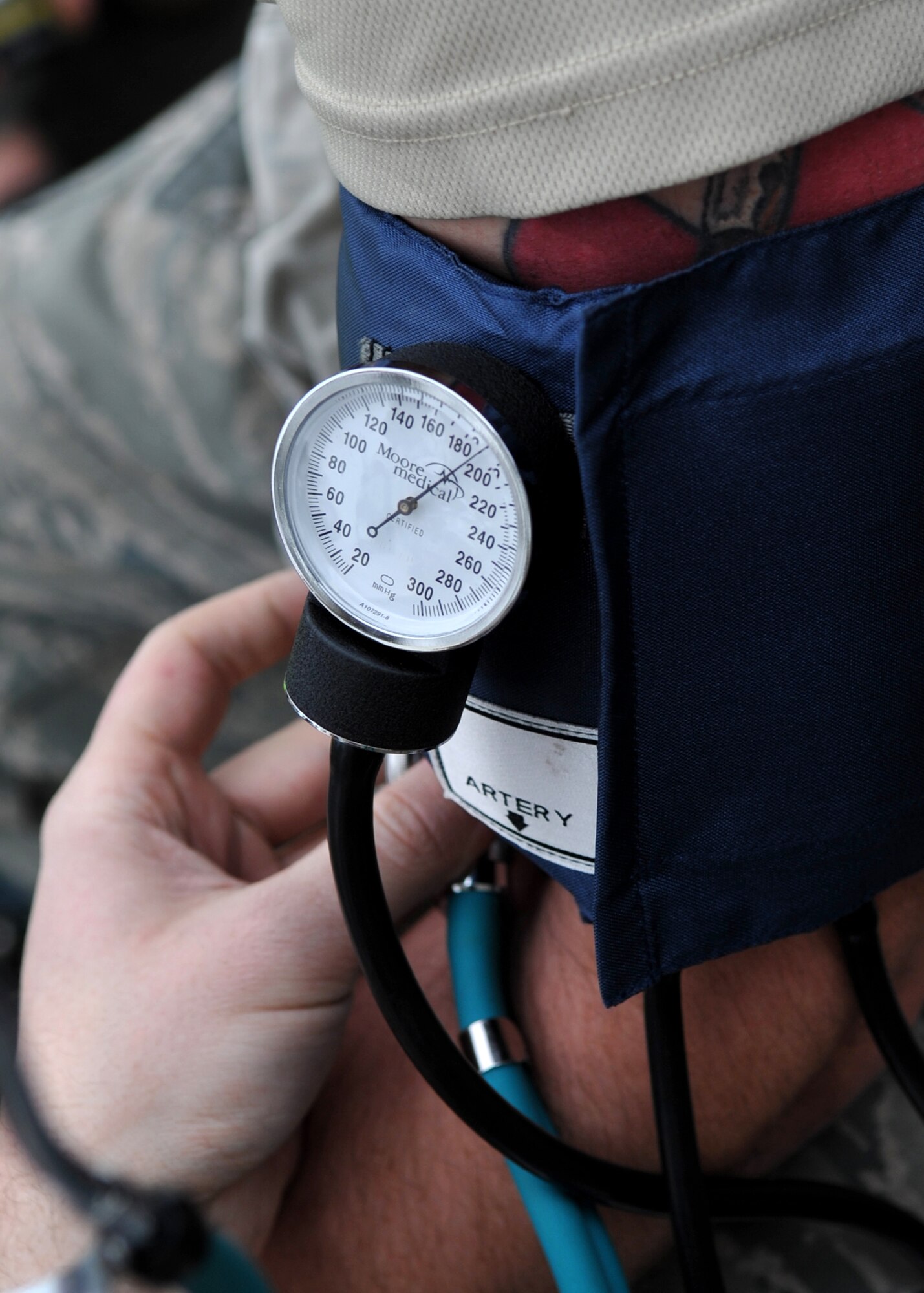 An Airman's vitals are checked before entering a "contaminated" room during an Emergency Management Exercise Dec. 1. The exercise simulated a biological attack and was designed to evaluate emergency responders and search and recovery efforts. (U.S. Air Force Photo /Senior Airman Evelyn Chavez)