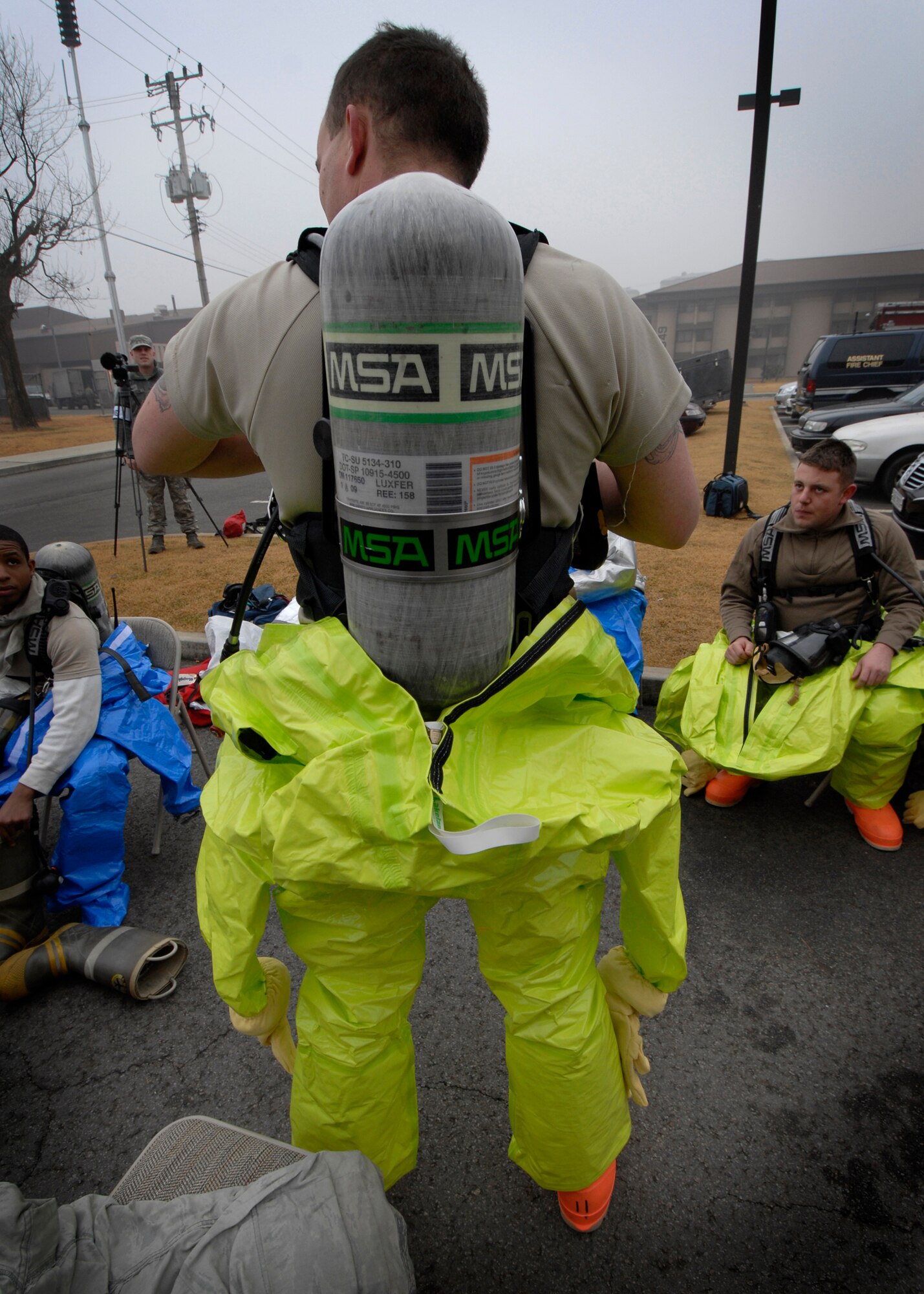 Staff Sgt. Casey Love, 51st Civil Engineer Squadron, prepares to enter a "contaminated room" during an Emergency Management Exercise Dec. 1.  The exercise simulated a biological attack where a hostile Airman planted a device in the HVAC system of a dorm building to disperse aerosolized botulism. The exercise was designed to evaluate emergency responders and search and recovery efforts. (U.S. Air Force Photo /Senior Airman Evelyn Chavez)