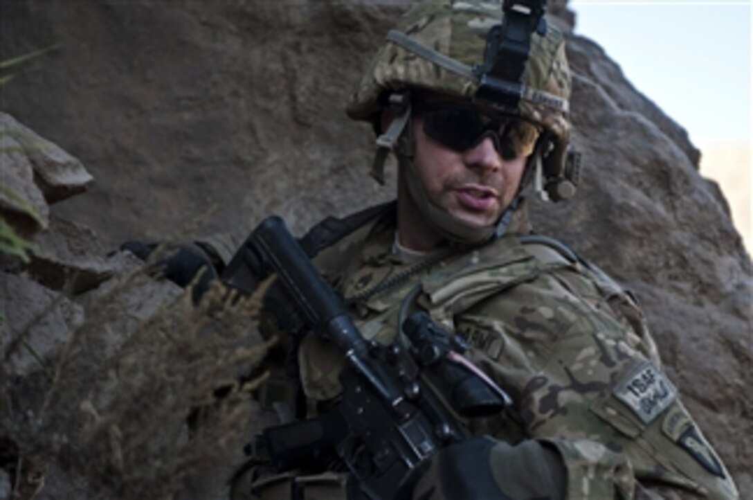 U.S. Army Staff Sgt. Lucas A. Kammerer, a squad leader assigned to Bushmaster Company, 1st Battalion, 327th Infantry Regiment, climbs down a hill after searching a cave for weapons during Operation Bulldog Bite in the Pech River valley, Kunar province, Afghanistan, on Nov. 25, 2010.  