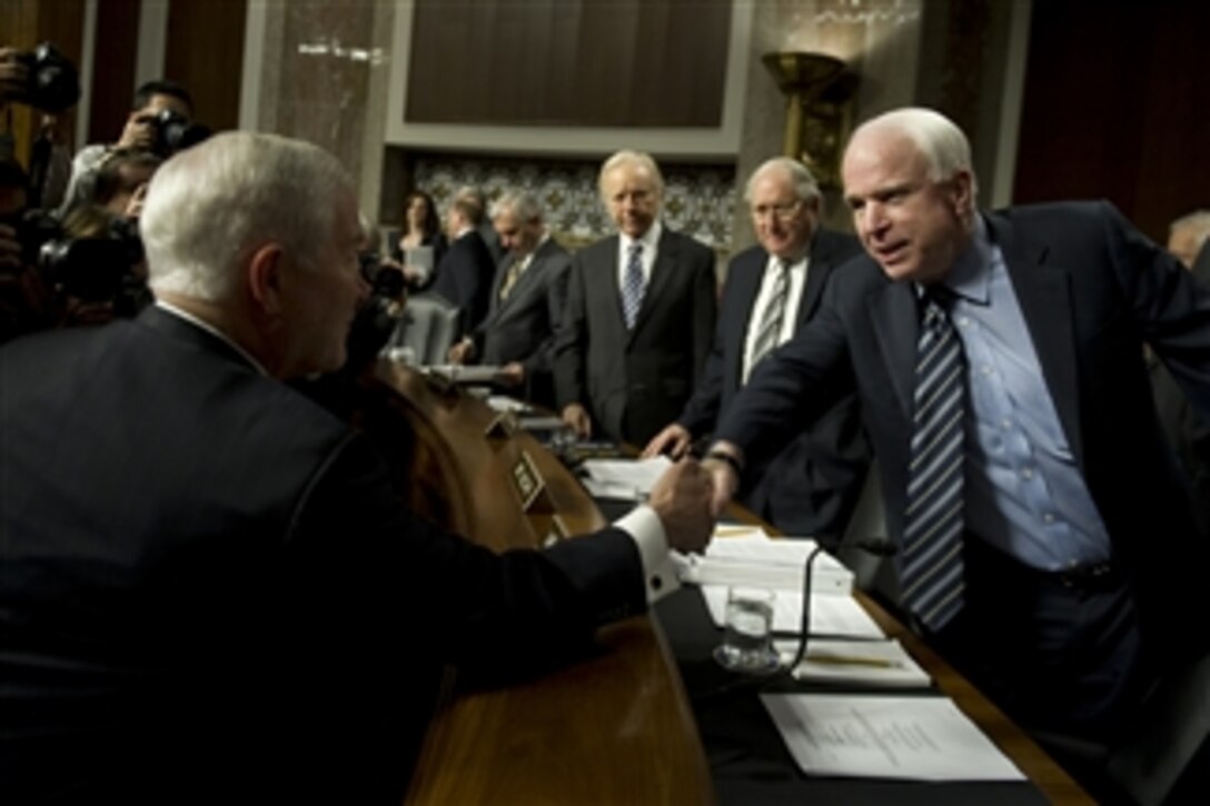 Secretary of Defense Robert M. Gates greets Sen. John McCain prior to testimony before the Senate Armed Services Committee on Dec. 2, 2010.  Gates was joined by Chairman of the Joint Chiefs of Staff Adm. Mike Mullen, Department of Defense General Counsel Jeh C. Johnson and Commander, U.S. Army Europe Gen. Carter Ham regarding the findings of the "Don't Ask, Don't Tell" Comprehensive Working Group report.  