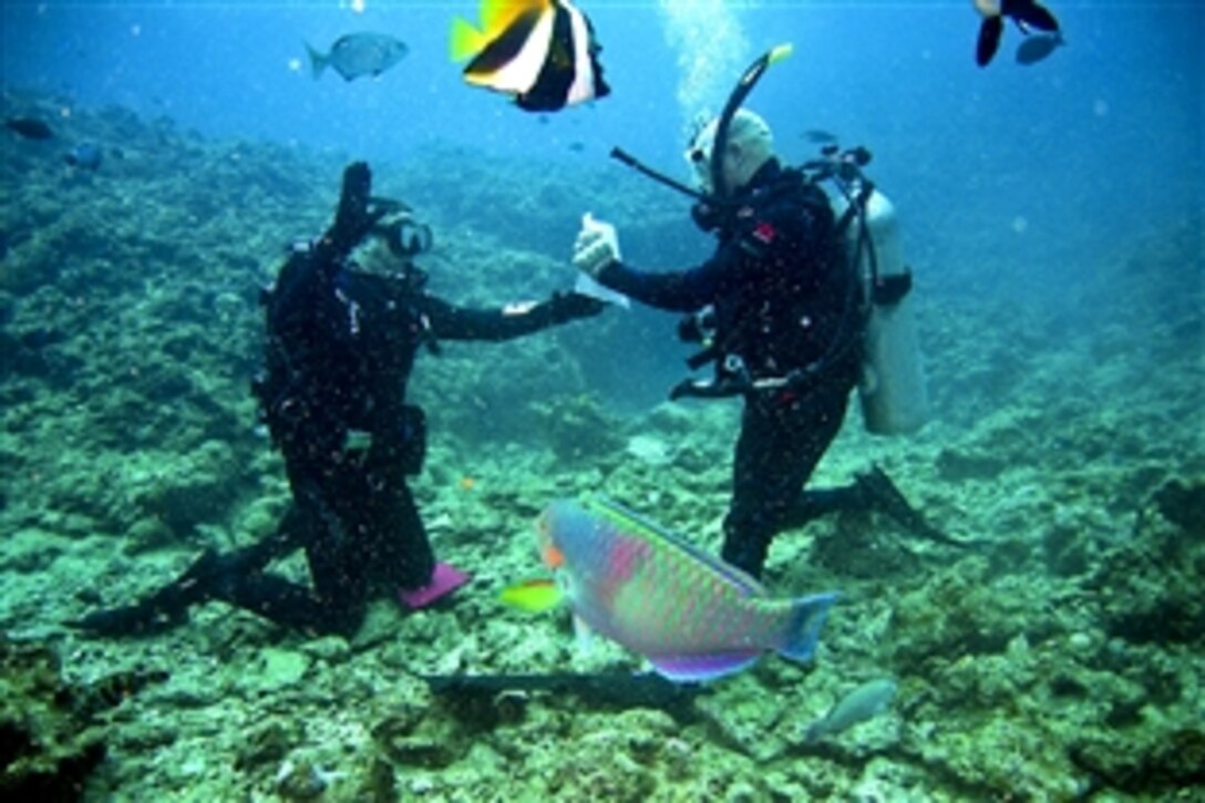 U.S. Marine Lt. Col. Brian Ehrlich, right, re-enlists U.S. Marine Corps Sgt. Aron D. Jarvi during an underwater ceremony at Maeda Point, Okinawa, Japan, Nov. 30, 2010. Jarvi, an avid scuba diver, enlisted in the Marine Corps for his second time during the ceremony. He is a warehouse clerk assigned to the Supply Battalion, Combat Logistics Regiment 35, 3rd Marine Expeditionary Force.