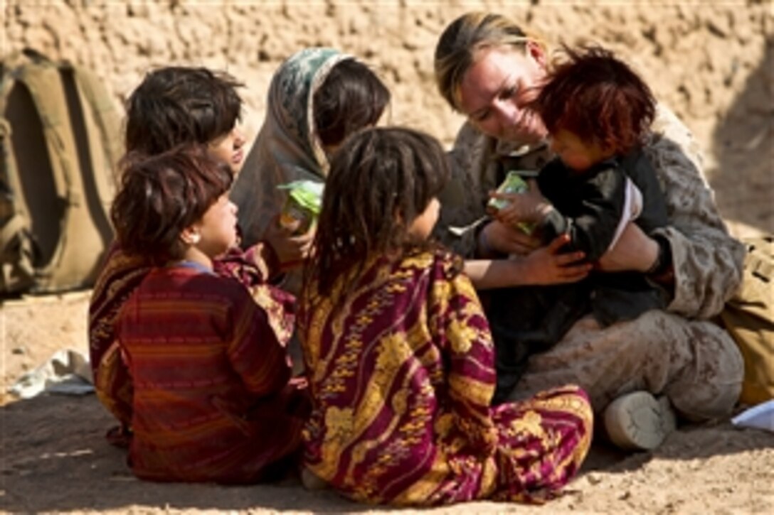 U.S. Marine Lance Corps Cpl. Riane Donoho plays with children as they wait to be seen at a village medical outreach conducted by U.S. Marines, members of the Danish Operational Mentor and Liaison Team, British Royal Air Force and the Afghan National Army in Boldak, Afghanistan, Nov. 22, 2010. Donoho is a member of the female engagement team assigned to 3rd Battalion, 25th Marine Regiment.