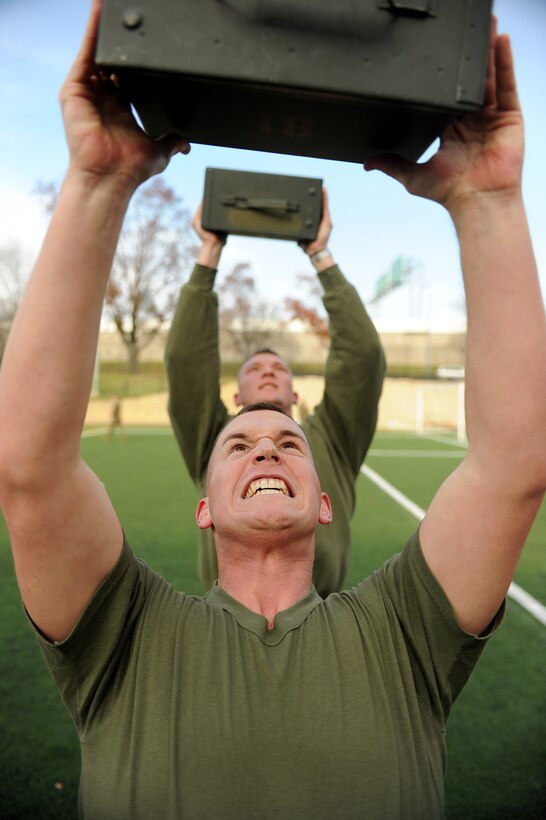 Cpl. Caleb Steel completes the ammo can portion of the Combat Fitness Test at Marine Barracks Washington Dec. 2. Steel, a member of the United States Marine Drum and Bugle Corps, completed the yearly test while enrolled in a barracks-wide Corporal's Course. (Photo by Bobby J. Yarbrough)