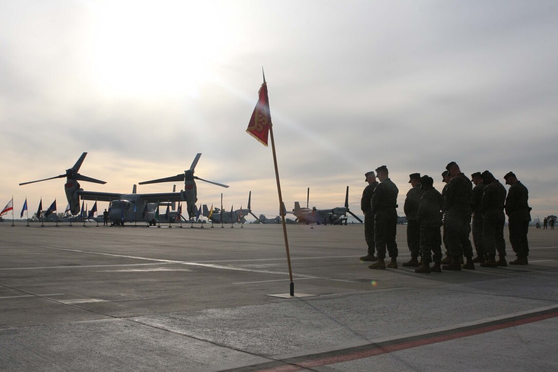 Marines from Marine Medium Tiltrotor Squadron 561, bow thier heads during a prayer at the squadron activation ceremony here, Dec. 2. VMM-561 is the first "Osprey" squadron on West Coast to begin from scratch.