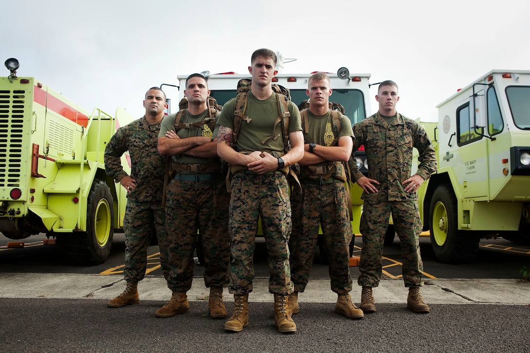Marine firefighters from Aircraft Rescue Firefighting, Marine Corps Air Station Kaneohe Bay, Hawaii, will hike the Honolulu Marathon Dec. 12 to raise money for Wounded Marines and sailors at Wounded Warrior Battalion West, Detachment Hawaii. From left to right, Sgt. Fernando Camacho, Cpl. Nathan Whitaker, Cpl. Ryan Guinty, Cpl. Brice Kuehn and Sgt. Brandon Cox, will don boots, woodland utility trousers, and 65 pounds of gear before beginning the 26.3-mile course. “We wanted to stand out among the other runners so everyone watching would know we were running for the wounded Marines and sailors,” Camacho said. “Being that we’re here and they’re serving overseas, we’re doing our part to raise some money and make sure they’re taken care of.”