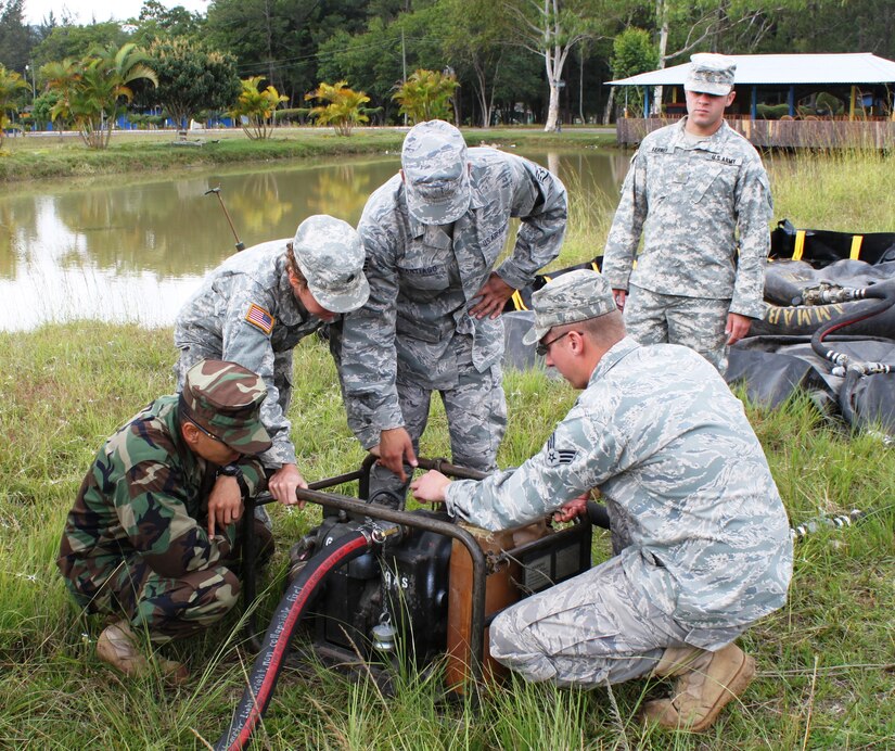 SOTO CANO AIR BASE, Honduras - Soldiers and Airmen from Joint Task Force-Bravo work on assembling a pump that would be used at a Forward Air Refueling Point.  FARP assembly training was part of a two-day exercise that included water purification.  JTF-B conducted the exercise at Fuerte General Hogar De Los in Siguatepeque, Honduras. (photo by Tech. Sgt. Edward Roldan)