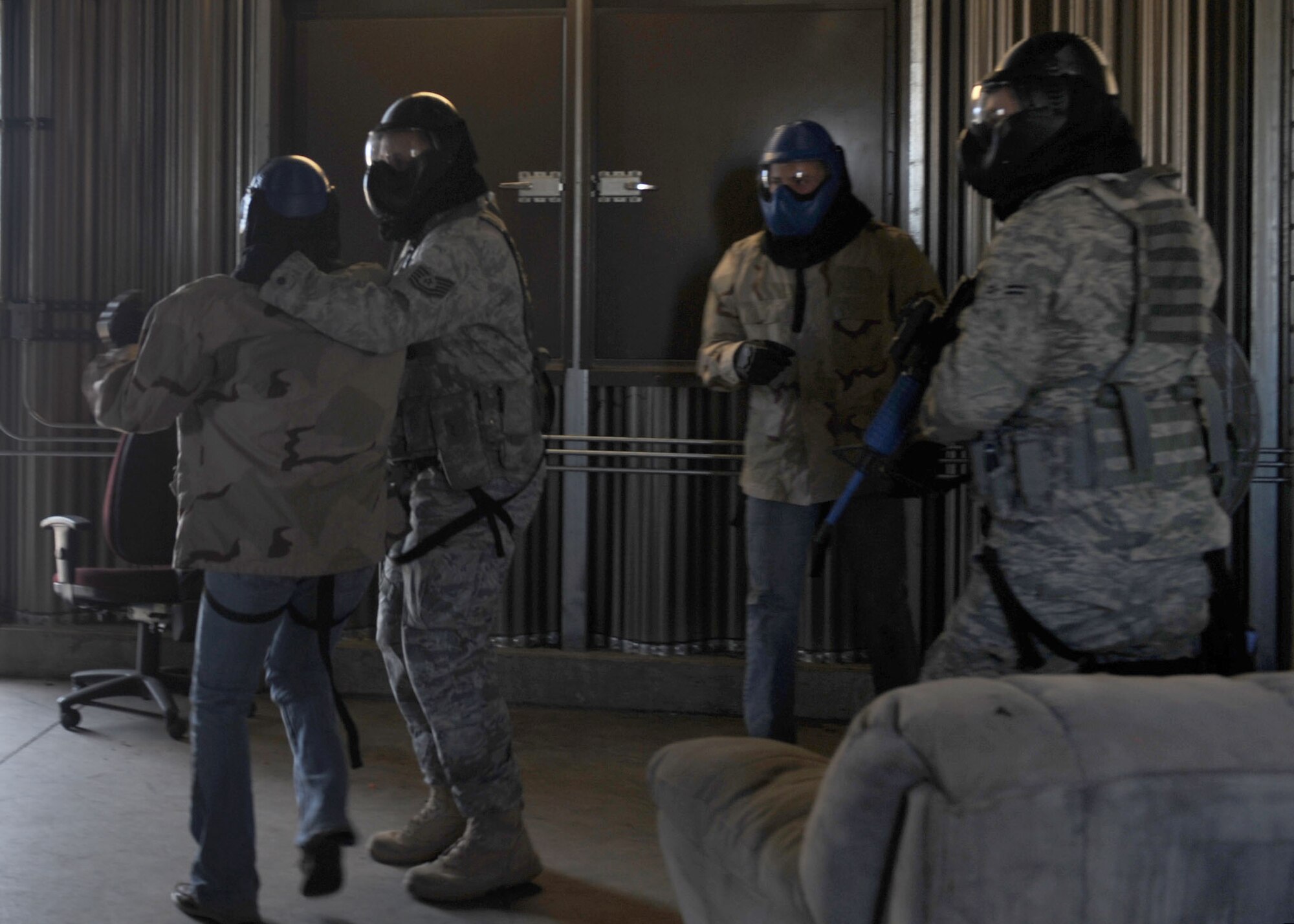 DAVIS-MONTHAN AIR FORCE BASE, Ariz. - Members of the 355th Security Forces Squadron apprehend a suspect during a scenario in their active shooter training exercise here Nov. 24. Security forces members use this training to remain mission-ready and prepare to defend the installation during any scenario. (U.S. Air Force photo/Senior Airman Brittany Dowdle)