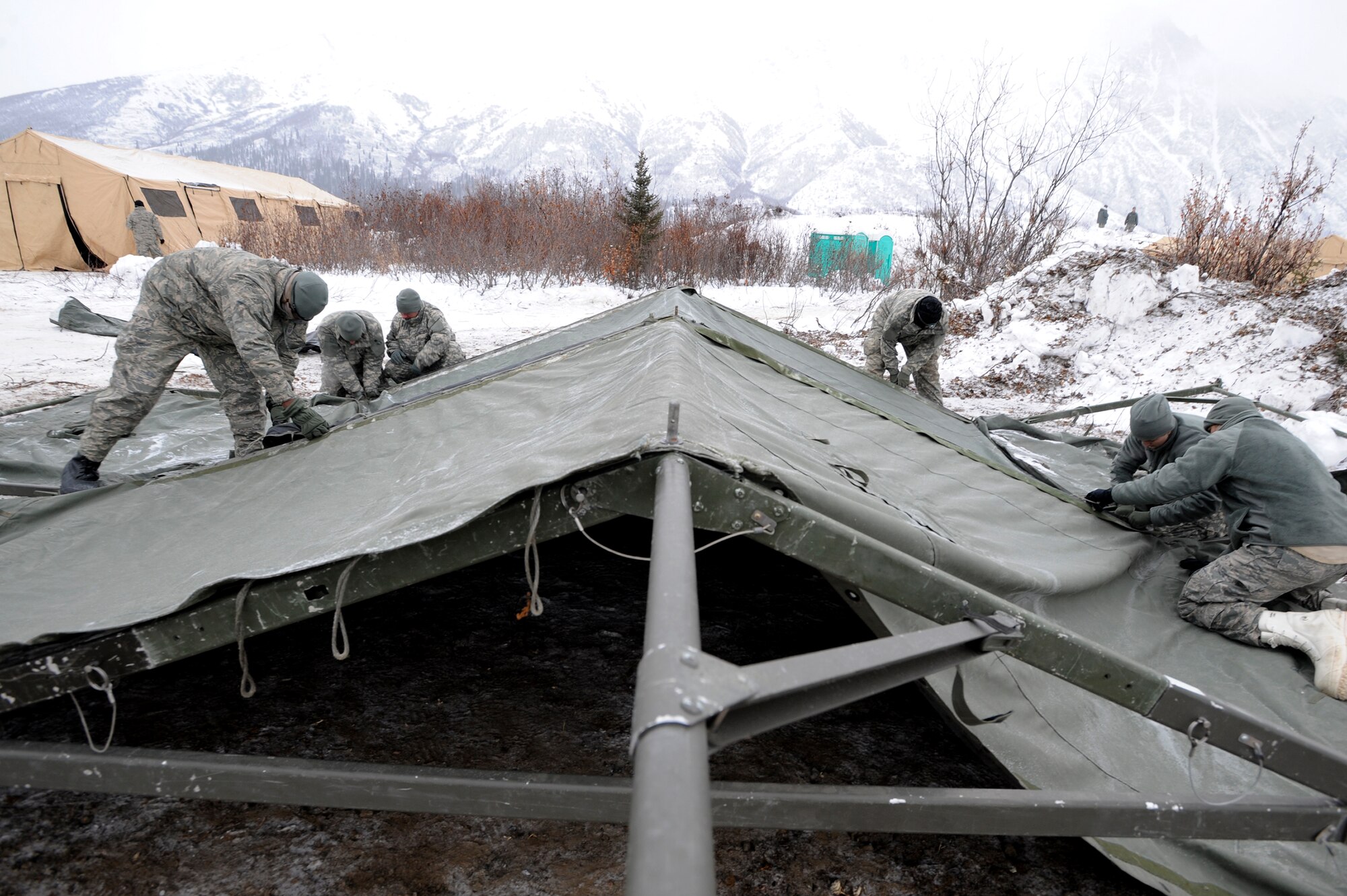 FORWARD OPERATING BASE GILLASPIE, Alaska -- Troops construct a tent, Nov. 22,  which served as a medical clinic for the 175 service members working at Site Raptor, near Cantwell, Alaska. (Photo by Air Force Staff Sgt. Joshua Garcia/JBER PAO)