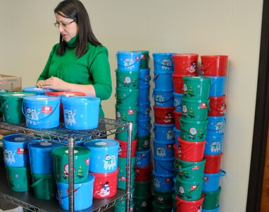 Randolph AFB, TX, 3 Dec. 2010:  Adalia Gonzalez, volunteer at Cookie Crunch, fills buckets of cookies to be sent out. (U.S. Air Force photo/Amn Alexis Siekert)