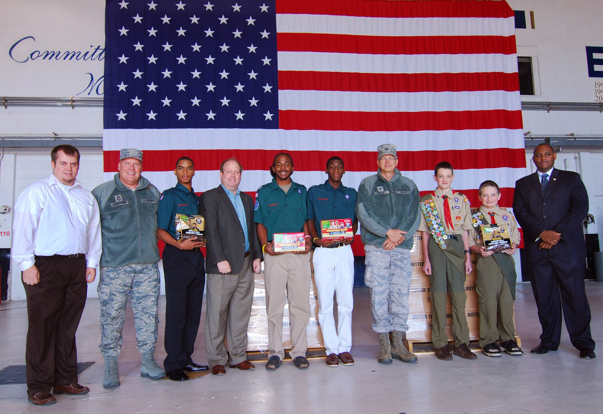Representatives from the Boy Scouts of America pose with 94th Airlift Wing Command Chief John Anderson and Commander Col. Timothy Tarchick at Dobbins Air Reserve Base Ga. Dec 3.  The Scouts were on base to see the offloading of a shipment of popcorn after they solicited donations from the public in order to provide this treat to military members here at the base.  (U.S. Air Force photo/ Brad Fallin)