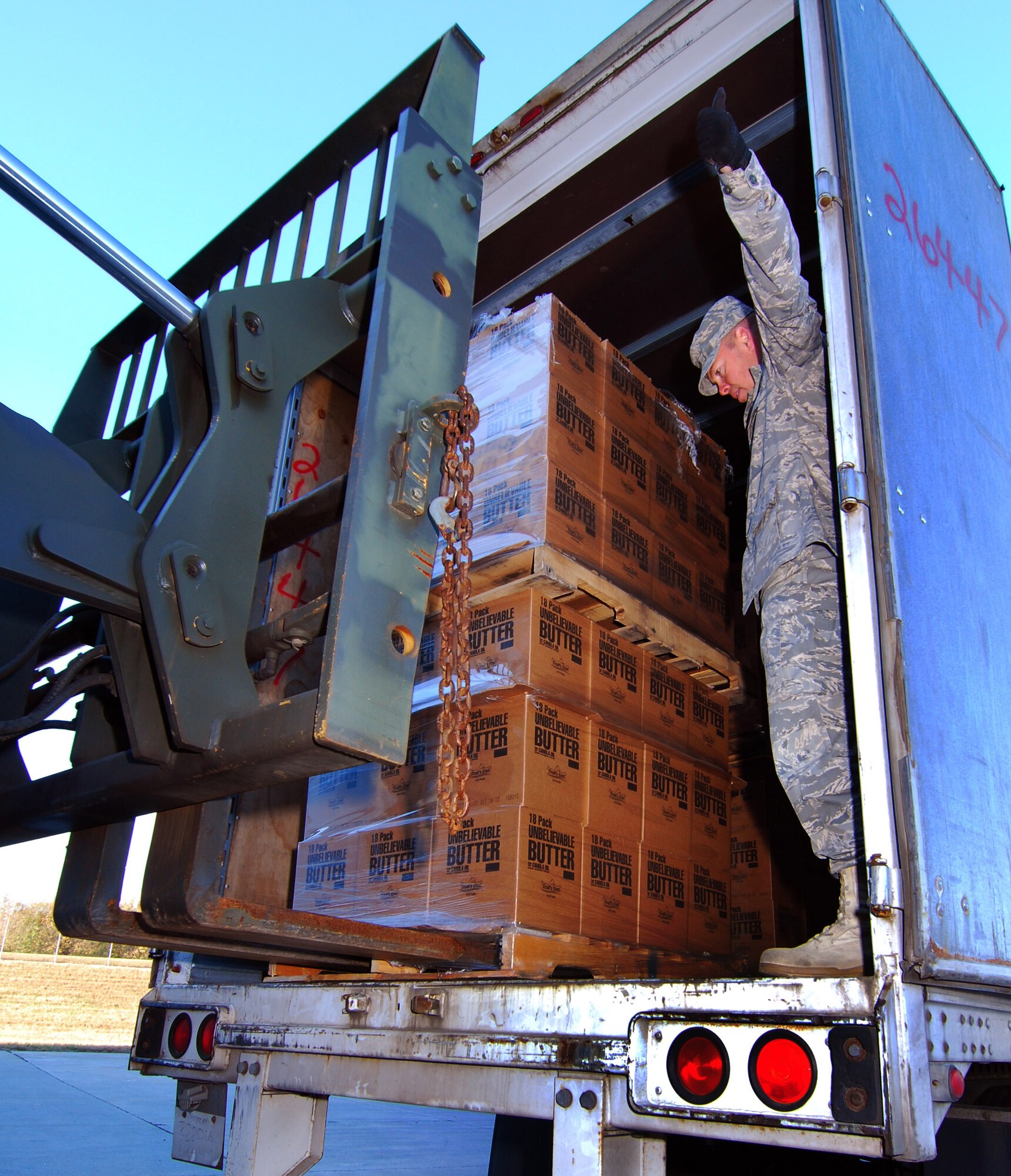 TSgt Dallas Criswell guides a forklift into position to offload a pallet of popcorn, Dec 3.  Tsgt Criswell is with the 94th Aerial Delivery Flight at Dobbins Air Reserve Base, Ga. and is helping receive a shipment of popcorn collected by Atlanta area Boy Scouts of America for donation to military members working at the base.   (U.S. Air Force photo/ Brad Fallin)