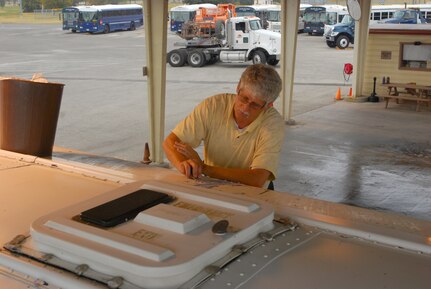 RANDOLPH AIR FORCE BASE, Texas -- Kirk Mason, 902nd Logistics Readiness Squadron vehicle control operations, removes adhesive graphics from a school bus.  902nd LRS vehicle control operations manages and serves just about every kind of vehicle one can think of on base, except boats or aircraft. They handle base bussed, taxis, government sedans, construction equipment and more. 
 (U.S. Air Force photo/Brian McGloin)
