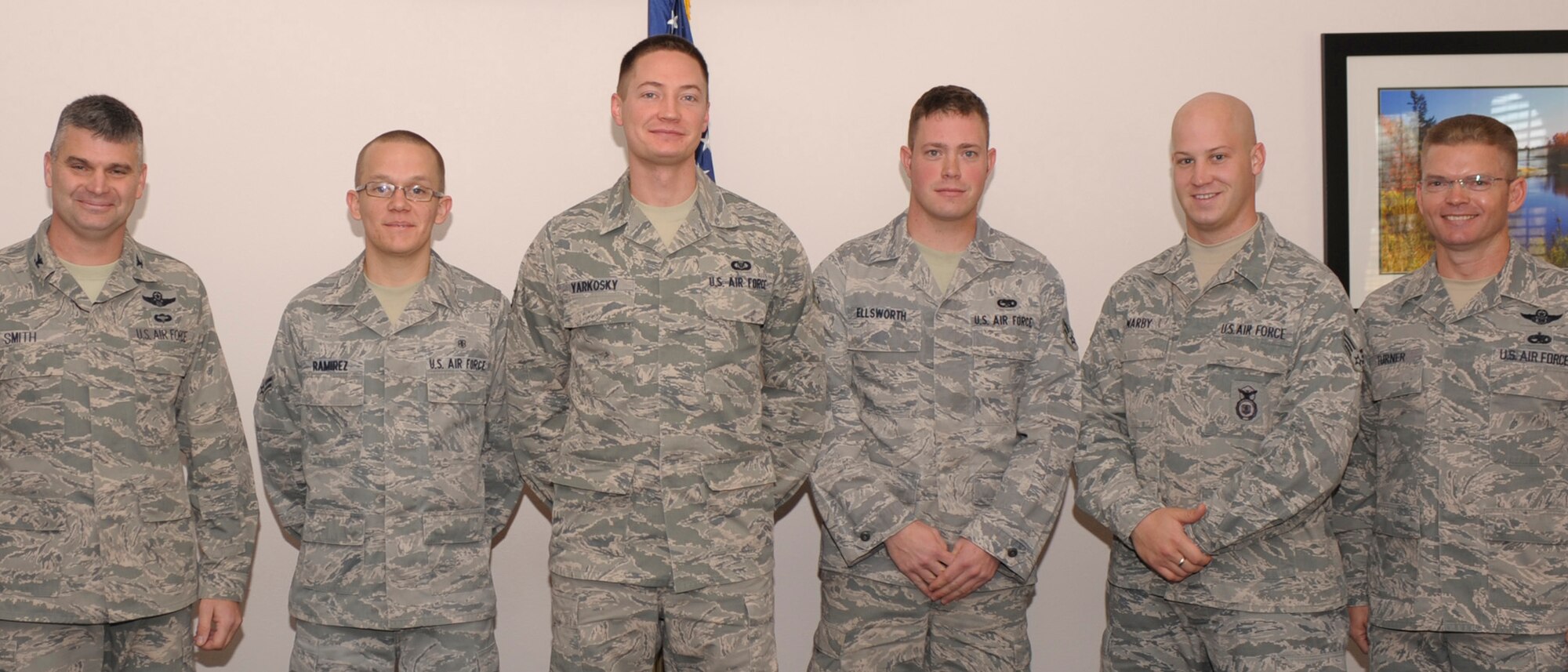 December Diamond Sharp winners, Airman 1st Class Nicholas Ramirez, 27th Special Operations Medical Group, A1C Cale Yarkosky, 16th Special Operations Squadron, A1C Eric Ellsworth, 27th Special Operations Communications Maitenence Squadron, and Senior Airman Russel Warby, 27th Special Operations Sercuirity Forces Squadron, stand with Col. Kirk Smith (far left), 27 Special Operations Wing vice commander, and Command Chief Master Sgt. William Turner (far right), 27th Special operations Wing Command Chief, after receiving their awards at the Peco's Trail Dining Facility Dec. 3. Diamond Sharp is a monthly awards program designed to recognize superior Airmen who exceed standards in all that they do. (U.S. Air Force photo Airman Basic Ericka Engblom)