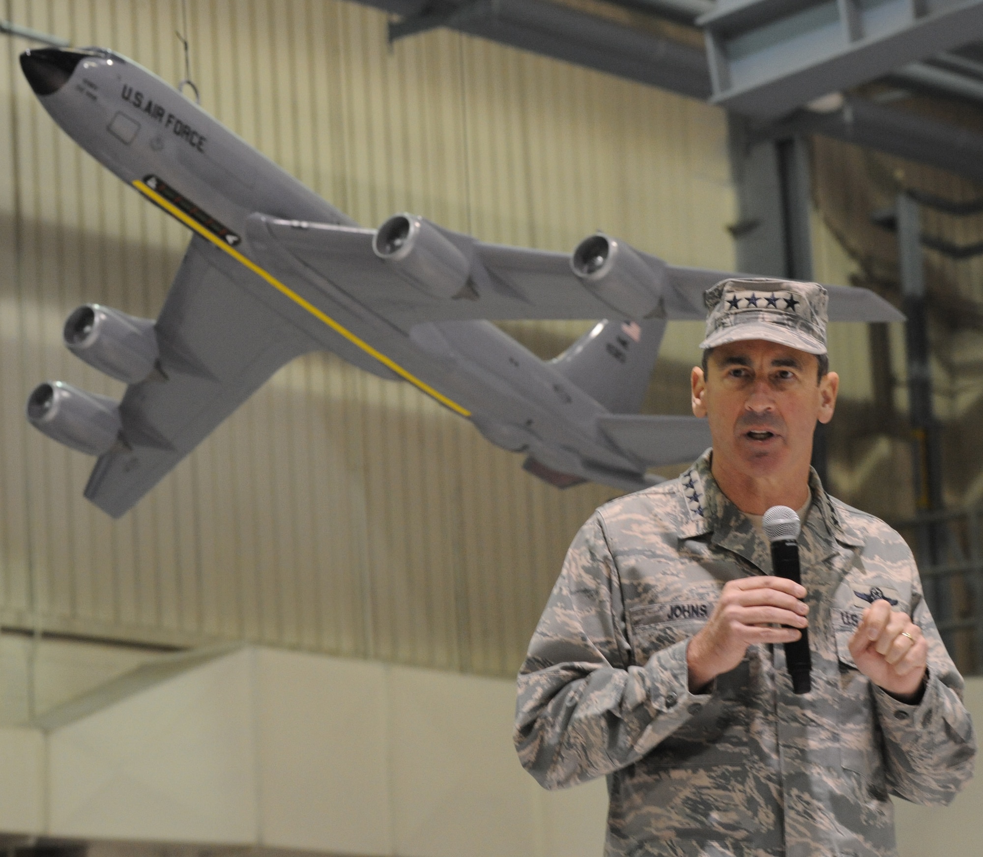Gen. Raymond Johns, Air Mobility Command commander, addresses the Warriors of the North during the mission complete ceremony Dec. 3, here. The ceremony was held to recognize the completion of 50 years of KC-135 Stratotanker flight and maintenance operations on base. Grand Forks Air Force Base is scheduled to receive Global Hawks in the summer of 2011. (U.S. Air Force photo by Tech. Sgt. Johnny Saldivar)