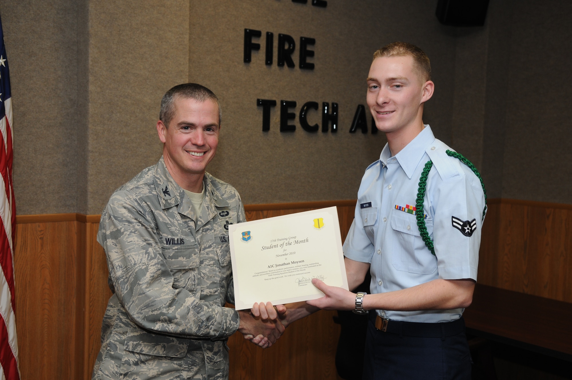GOODFELLOW AIR FORCE BASE, Texas -- Airman 1st Jonathan Moysen, 316th Training Squadron, accepts his November Student of the Month award from Col. J.D. Willis, 17th Training Group Commander. (U.S. Air Force photo/Airman 1st Class Clayton Lenhardt)
