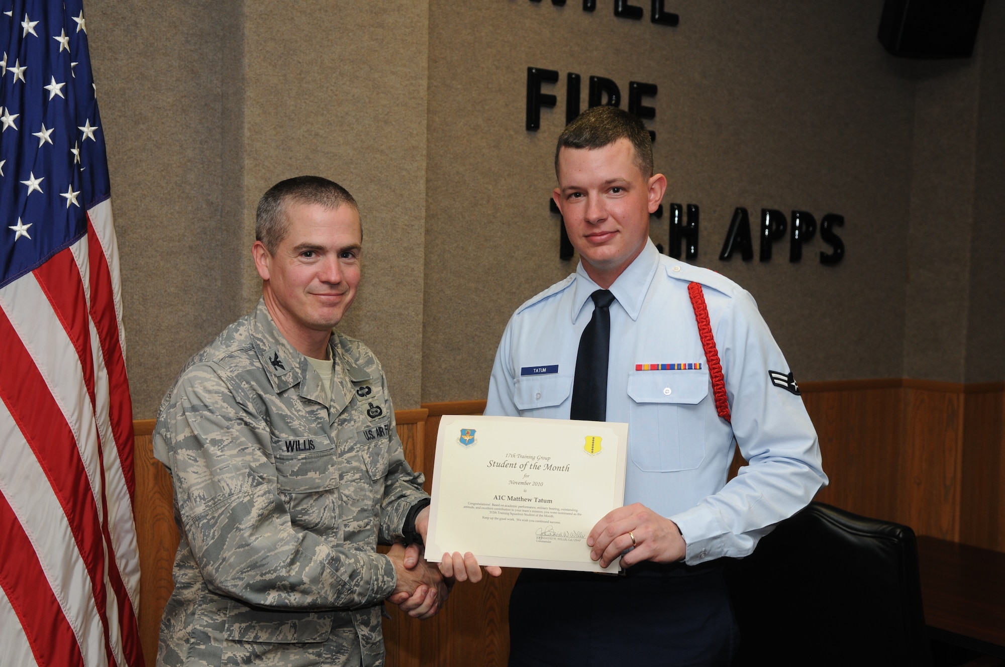 GOODFELLOW AIR FORCE BASE, Texas -- Airman 1st Class Matthew Tatum, 312th Training Squadron, accepts his November Student of the Month award from Col. J.D. Willis, 17th Training Group Commander. (U.S. Air Force photo/Airman 1st Class Clayton Lenhardt)