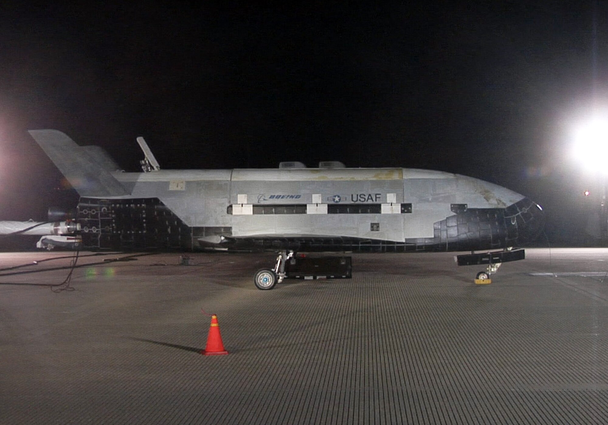 The X-37B sits on the Vandenberg Air Force base runway during post-landing operations Dec. 3. The X-37B, named Orbital Test Vehicle 1 (OTV-1), conducted on-orbit experiments for more than 220 days during its maiden voyage. It fired its orbital maneuver engine in low-earth orbit to perform an autonomous reentry before landing. (U.S. Air Force photo/ Michael Stonecypher)