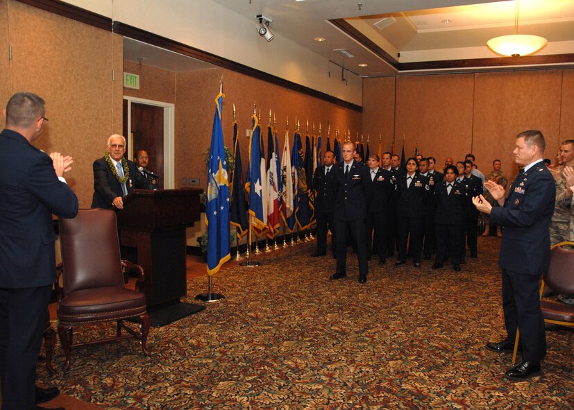 The Travis Community gives the plans and requirements flight chief of the 60th Communications Squadron Mr. Richard Wetzel, at podium, a standing ovation during  his retirement ceremony.   Mr. Wetzel retired after fifty years of Civil Service to the United States on 15 October 2010 at Travis Air Force Base, California. (U.S. Air Force photo by Civ/Nan Wylie)