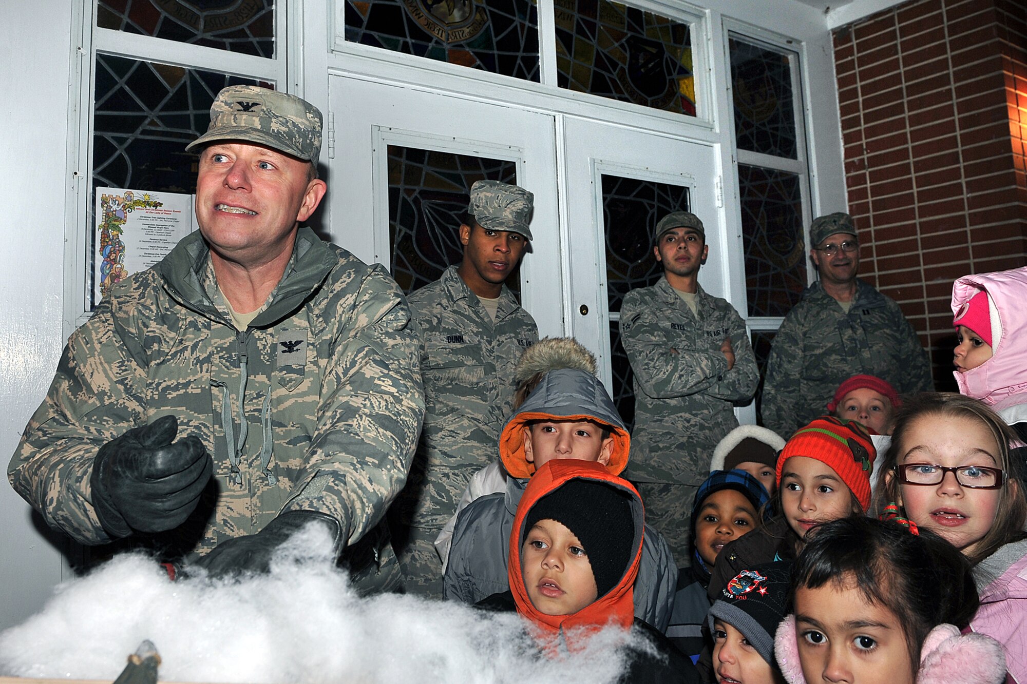OFFUTT AIR FORCE BASE, Neb. - Col. Michael Allshouse, 55th Mission Support Group commander, lifts the light switch while children from the Offutt community watch during the tree lighting and holiday events outside the SAC Memorial Chapel Dec. 2. This annual event provides Team Offutt member and their families a fun environment to share their joy and give presents to their love ones this Christmas season.  U.S. Air Force Photo by Charles Haymond