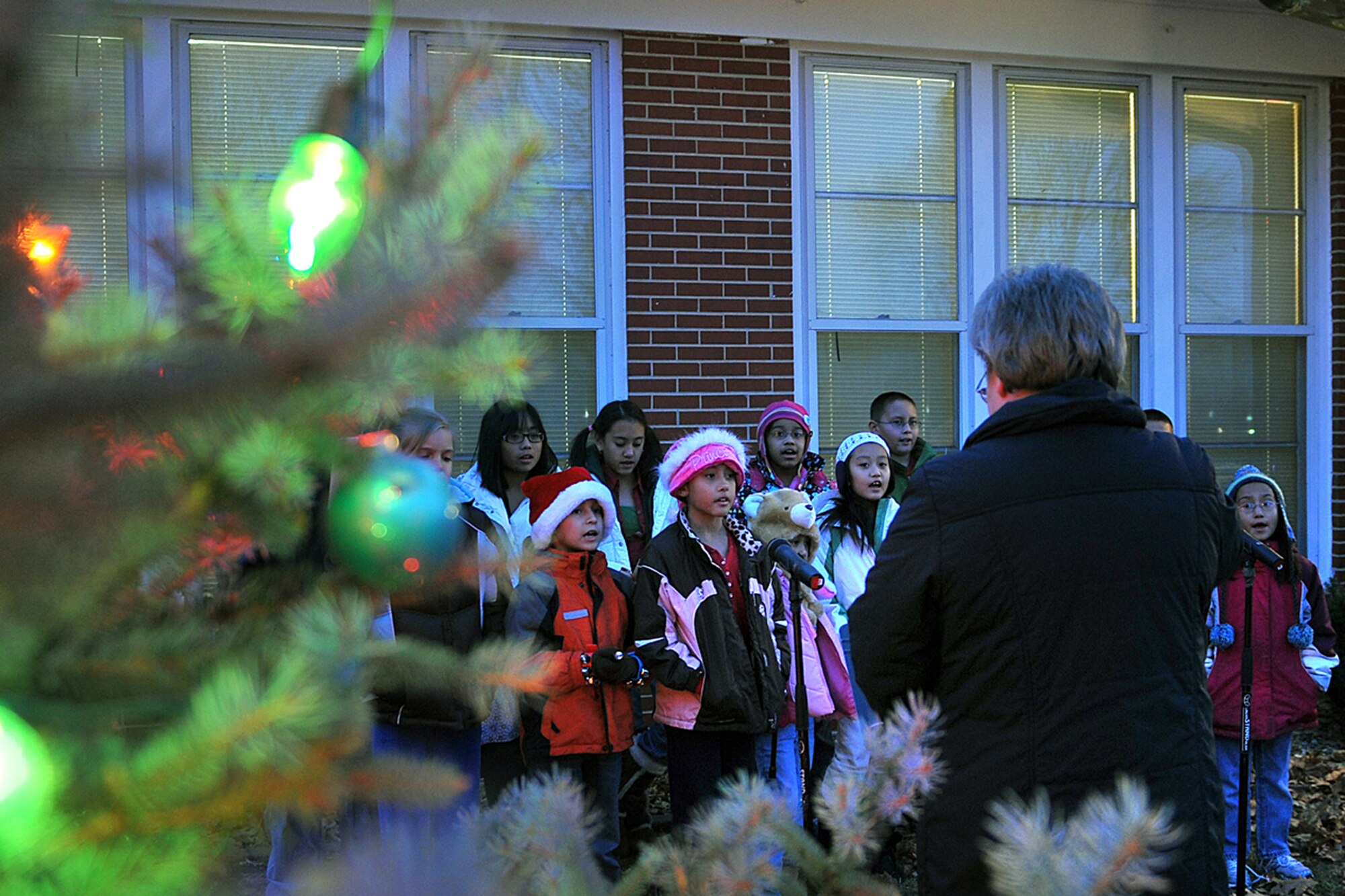 OFFUTT AIR FORCE BASE, Neb. - Offutt?s chapel children choir sing carols during the tree lighting and holiday events outside the SAC Memorial Chapel Dec. 2. This annual event provides Team Offutt member and their families a fun environment to share their joy and give presents to their love ones this Christmas season.  U.S. Air Force Photo by Charles Haymond