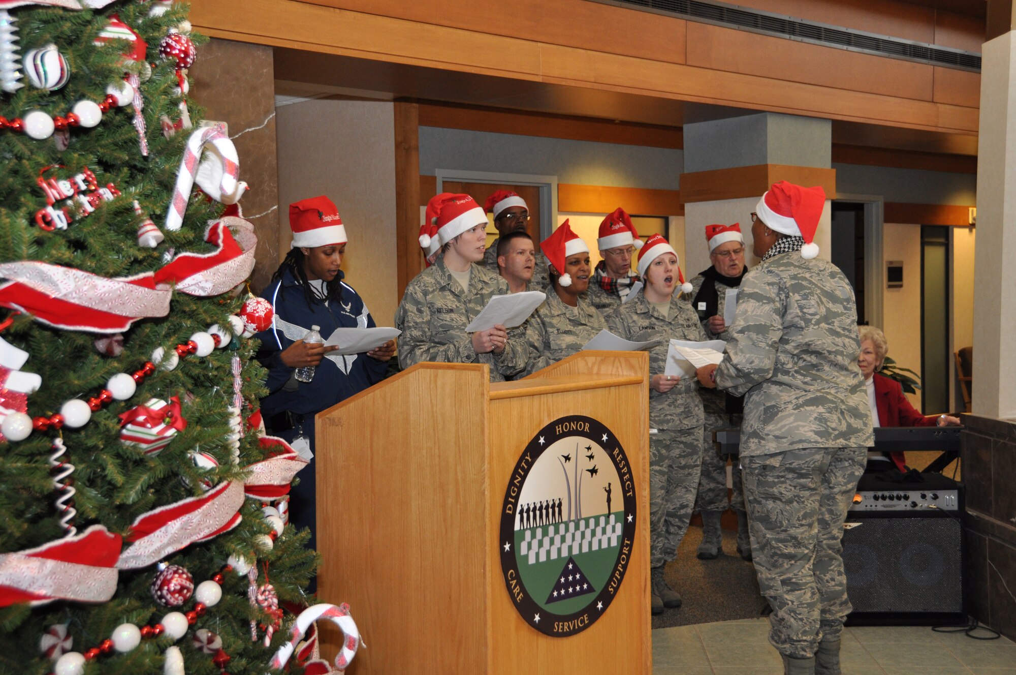Ch. (Lt. Col.) Paula Payne leads carolers during a tree lighting ceremony Dec. 1, 2010 at Air Force Mortuary Affairs Operations. The chaplains orchestrated the event to welcome in the holiday season. (U.S. Air Force photo/Staff Sgt. Jamie George)
