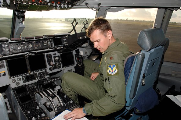 Crew member Maj. Graham Boutz, a pilot with the 13th Air Force, goes through a pre-flight inspection at Joint Base Pearl Harbor Hickam, Hawaii in preparation for the final flight of Lt. Gen. Herbert "Hawk" Carlisle as the 13th Air Force commander Nov. 30. General Carlisle's final flight was supported by the 15th Wing's 535th Airlift Squadron here. General Carlisle has been confirmed for assignment as Deputy Chief of Staff, Operations, Plans and Requirements, Headquarters U.S. Air Force, Washington, D.C. (U.S. Air Force photo by Mark Bates)