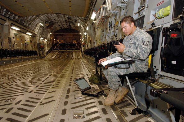 Tech. Sgt. Dustin Ching, 154th Maintenance Squadron crew chief refers to a reference log for data inputs at Joint Base Pearl Harbor Hickam in preparation for the final flight of Lt. Gen. Herbert "Hawk" Carlisle as the 13th Air Force commander Nov. 30. General Carlisle's final flight was supported by the 15th Wing's 535th Airlift Squadron at here. General Carlisle has been confirmed for assignment as Deputy Chief of Staff, Operations, Plans and Requirements, Headquarters U.S. Air Force, Washington, D.C. (U.S. Air Force photo by Mark Bates)