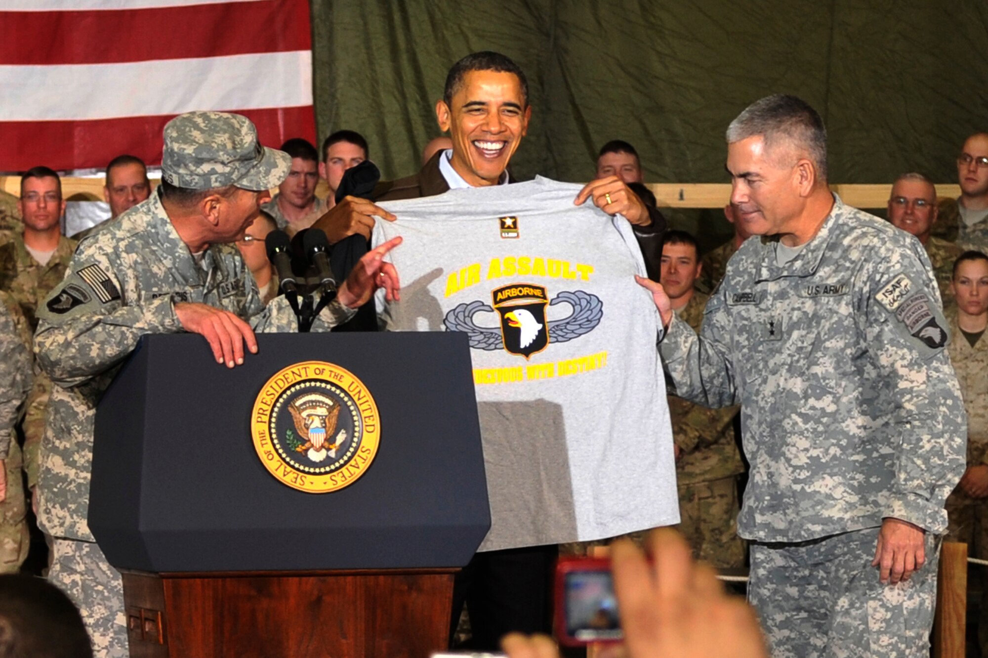 President Barack Obama is presented with a shirt by Maj. Gen. John Campbell, 101st Combined Joint Task Force commander, during a visit to Bagram Airfield, Afghanistan, Dec. 3, 2010. President Obama addressed current issues including the troop surge, pay freeze and extended his appreciation to the men and women of the armed forces serving around the world. (U.S. Air Force photo/Staff Sgt. Christopher Boitz) 