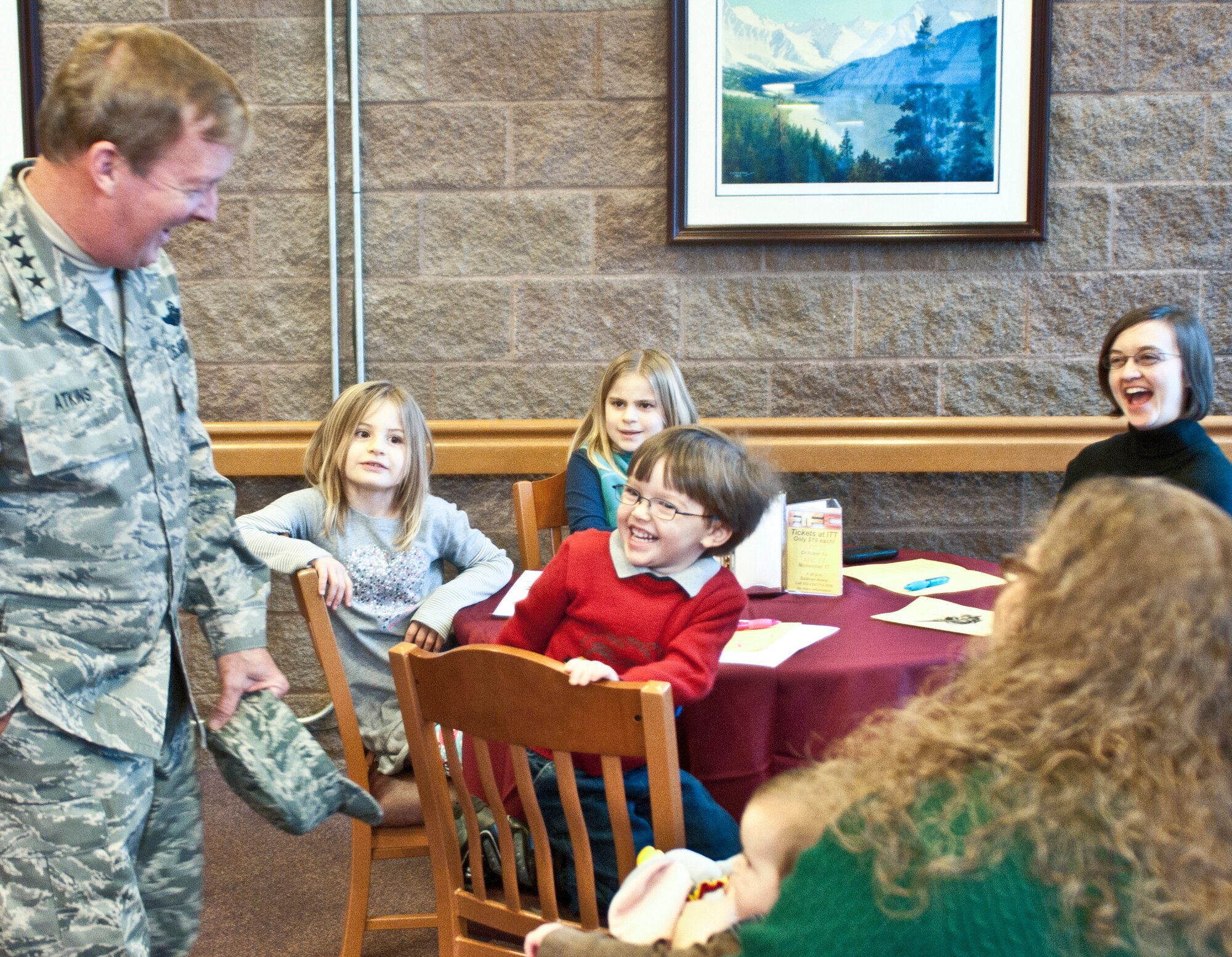 JOINT BASE ELMENDORF-RICHARDSON, Alaska -- Air Force Lt. Gen. Dana Atkins, Alaskan Command commander, meets Noah Hall at the Iditarod Dining Facility, Thanksgiving. (Photo by Steve White/JBER PAO)