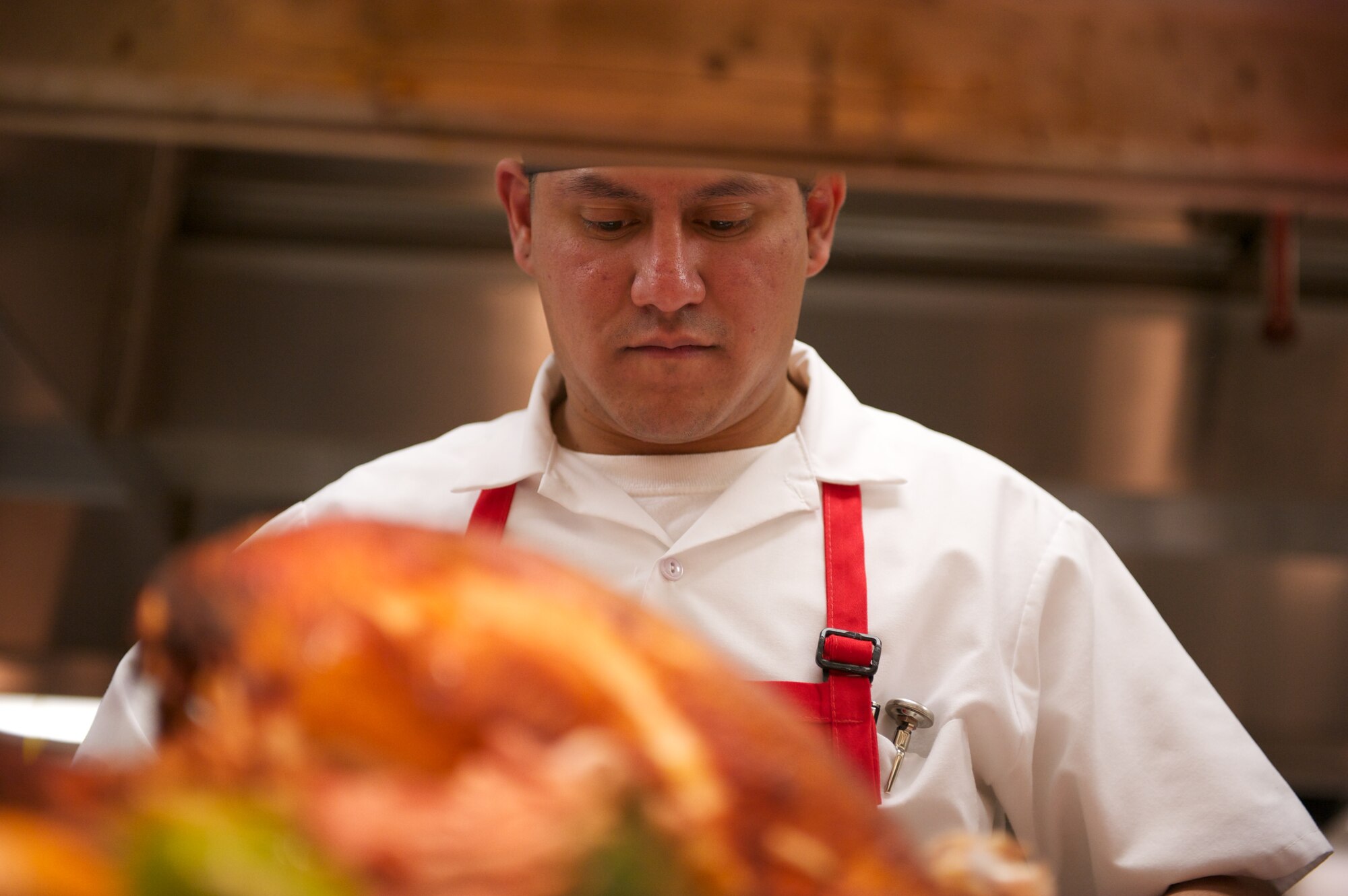 JOINT BASE ELMENDORF-RICHARDSON, Alaska -- Omar Gonzalez, Gold Rush Inn Dining Facility, carves up a turkey, Thanksgiving. (Photo by David Bedard/JBER PAO)